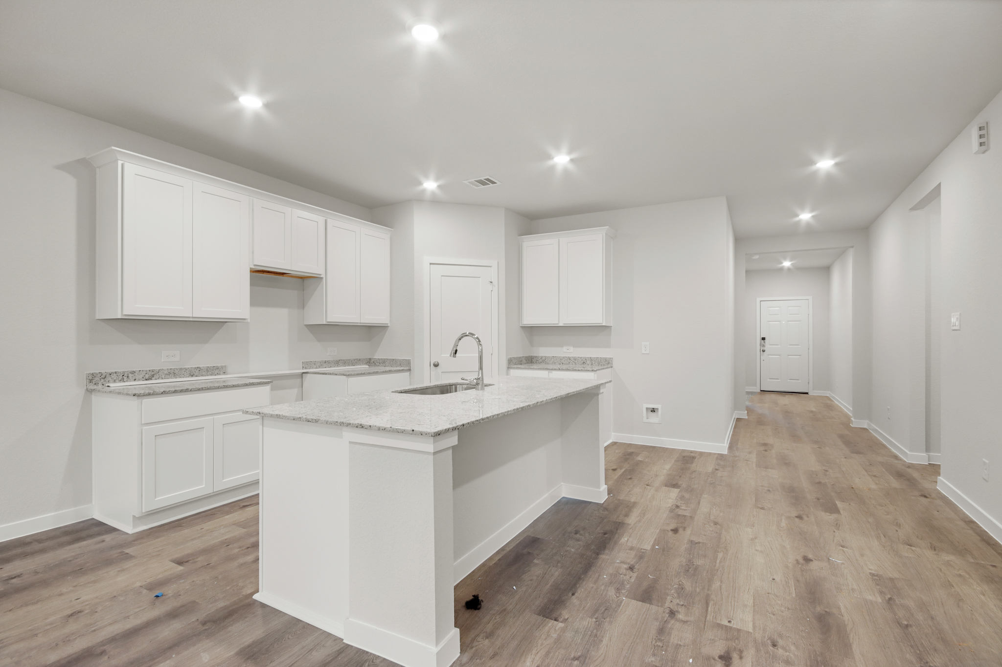 A kitchen with white cabinets.