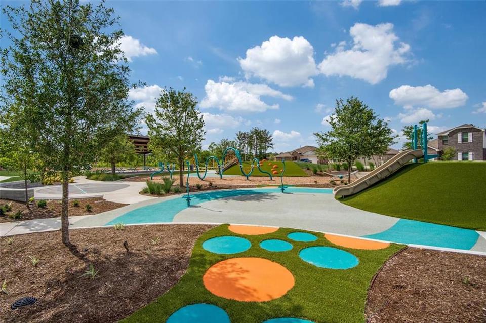 A large green park with a swimming pool.