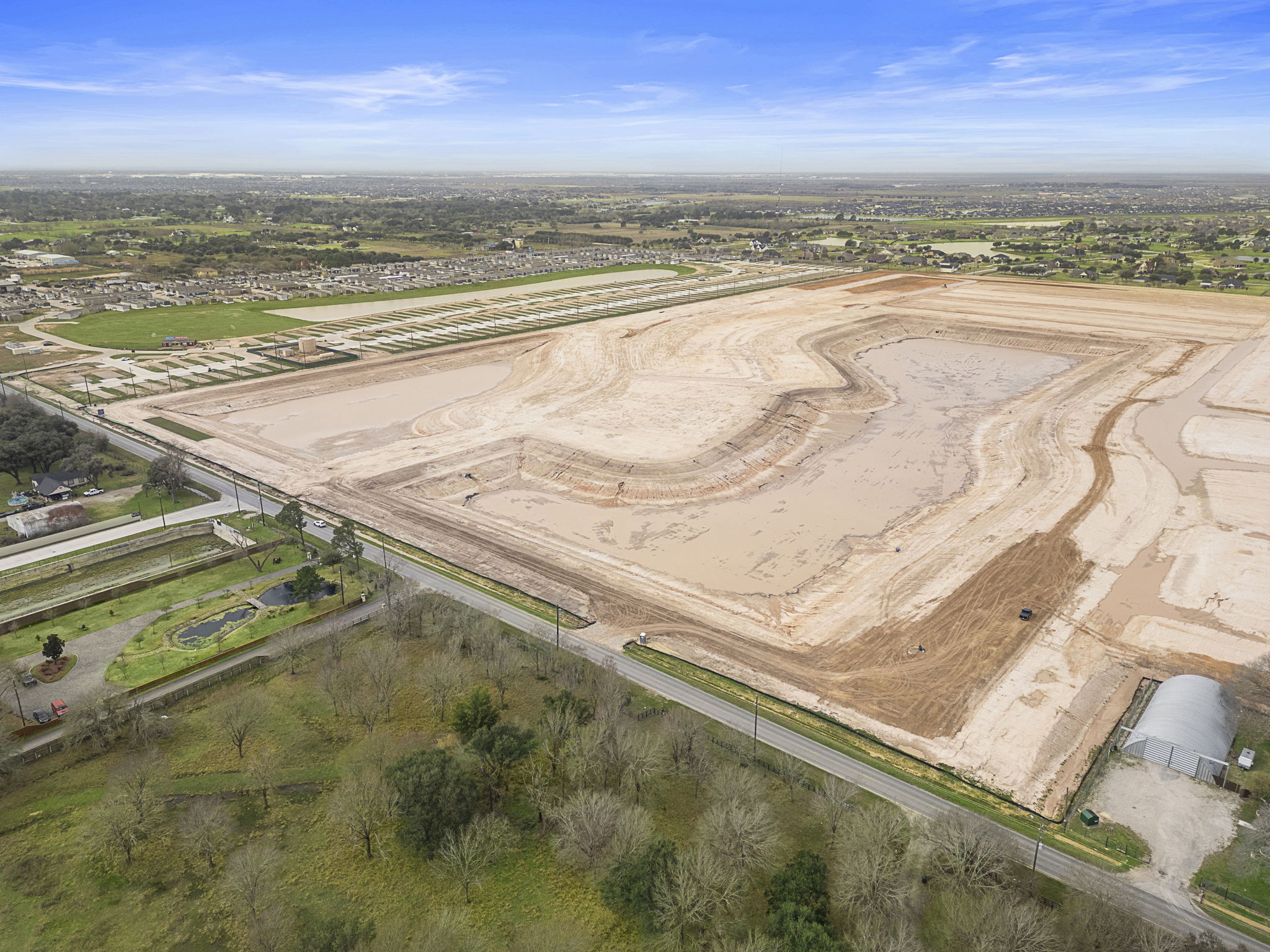 A large field with many trees.