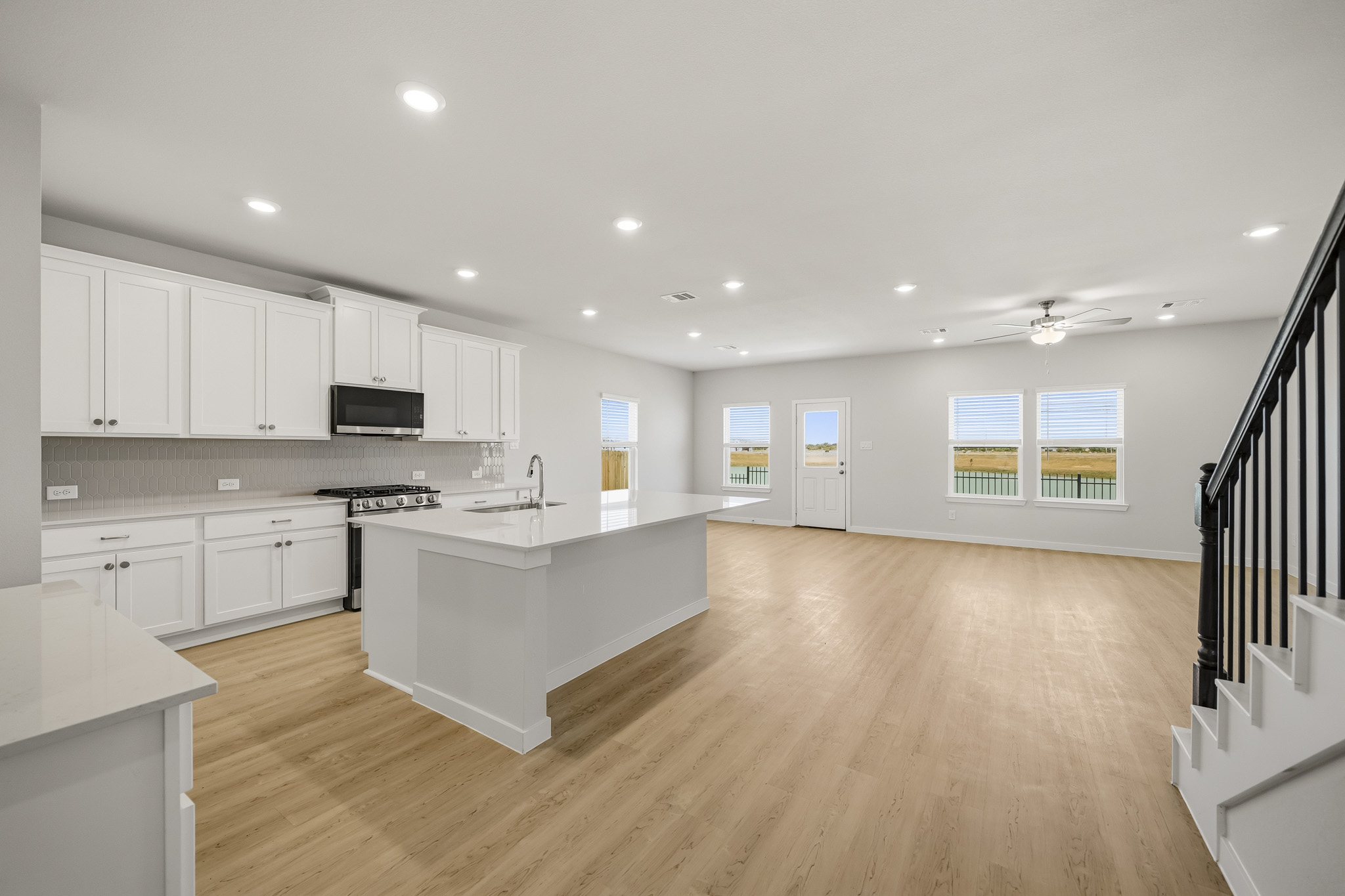 A large kitchen with white cabinets.