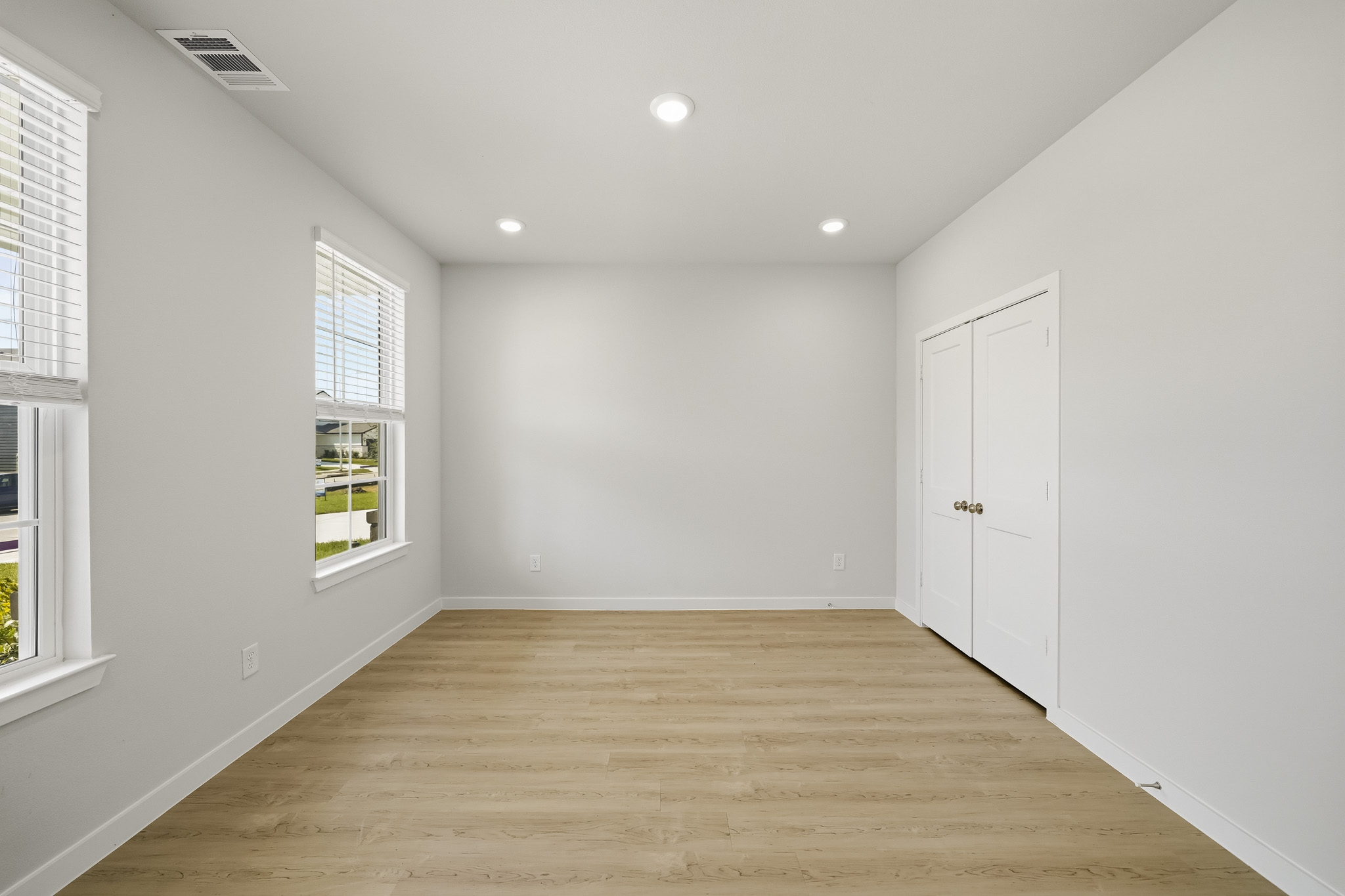 A room with white walls and windows.