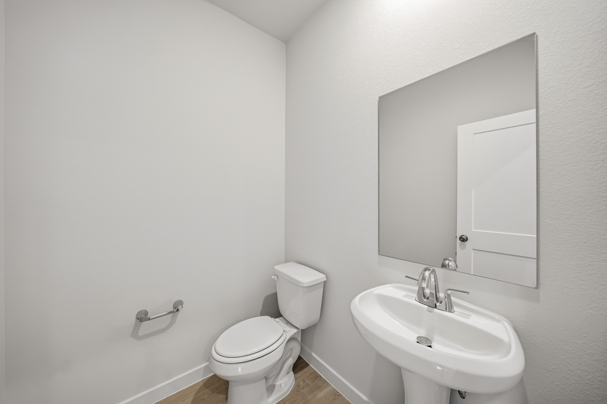 A bathroom with a toilet and sink.