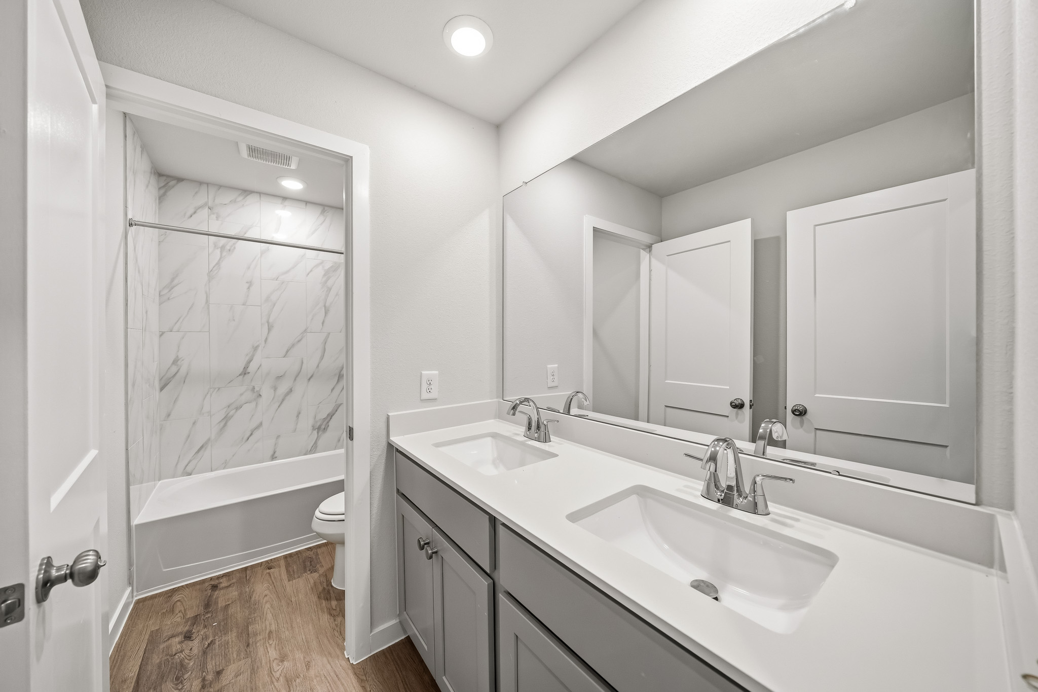 A bathroom with a tub sink and a shower.