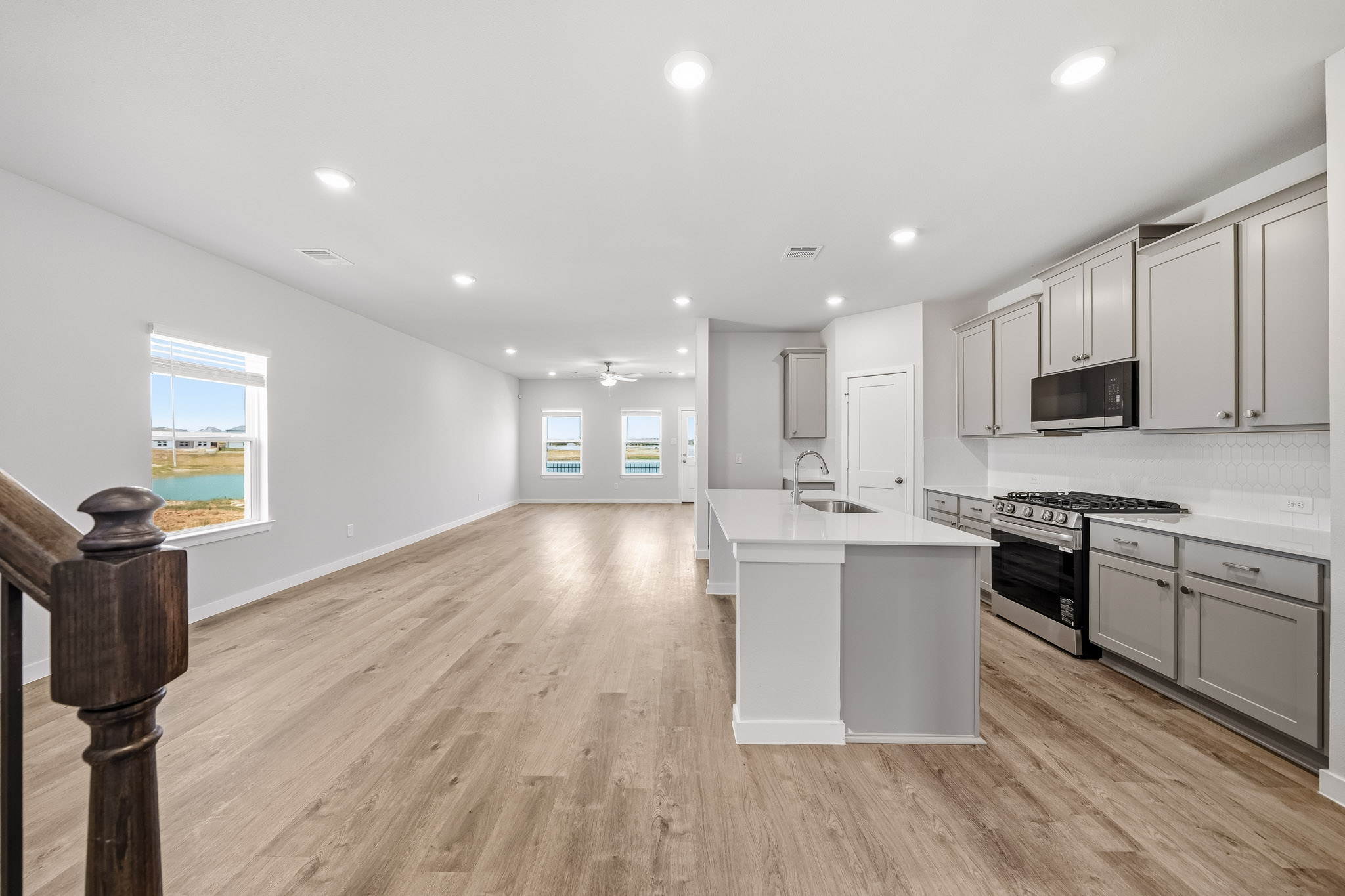 A kitchen with white cabinets.
