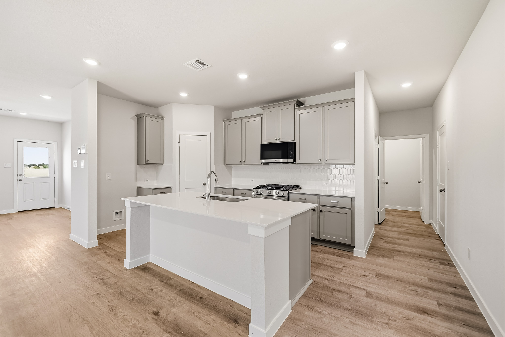 A kitchen with white cabinets.