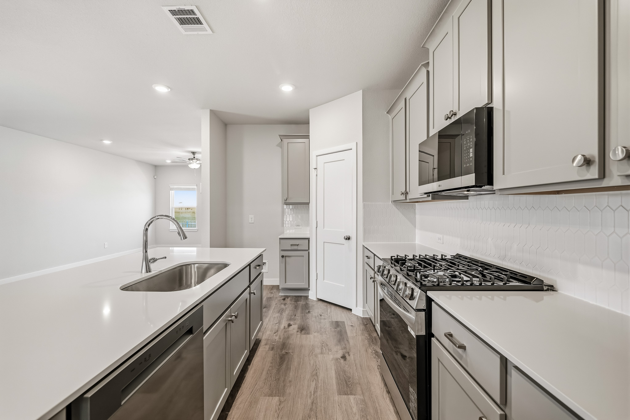 A kitchen with white cabinets.