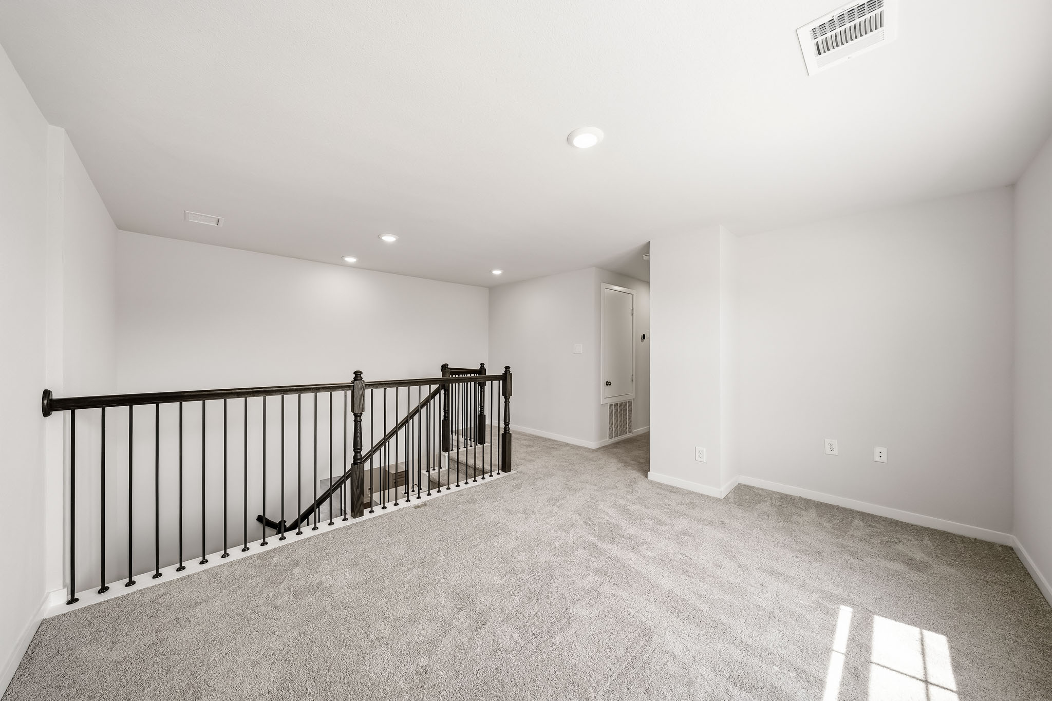 A hallway with a railing.