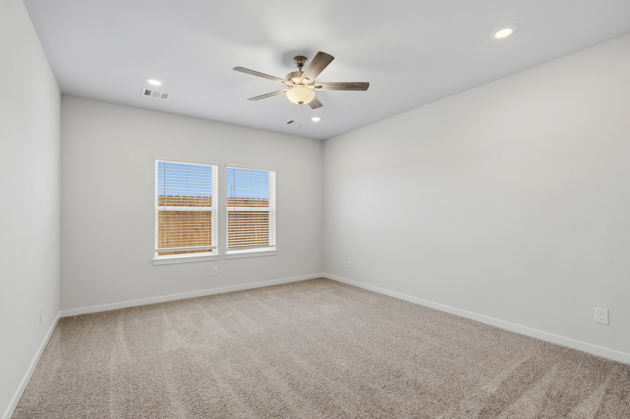 A room with a ceiling fan and a ceiling fan.