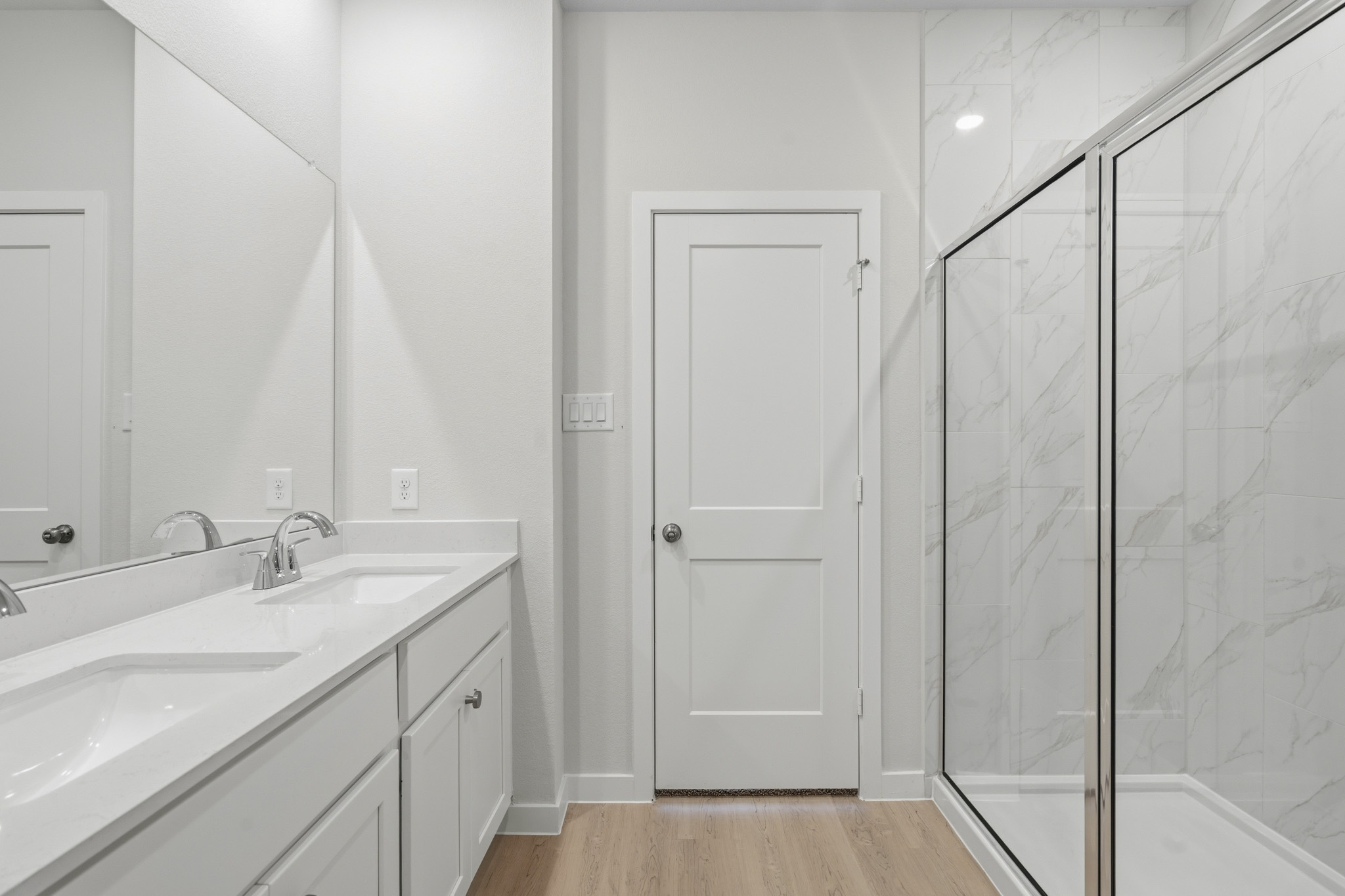 A bathroom with a glass shower.