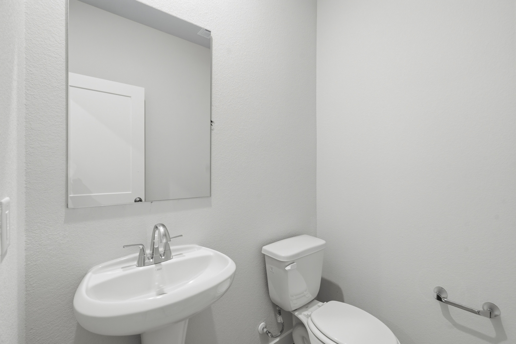 A bathroom with a sink and toilet.