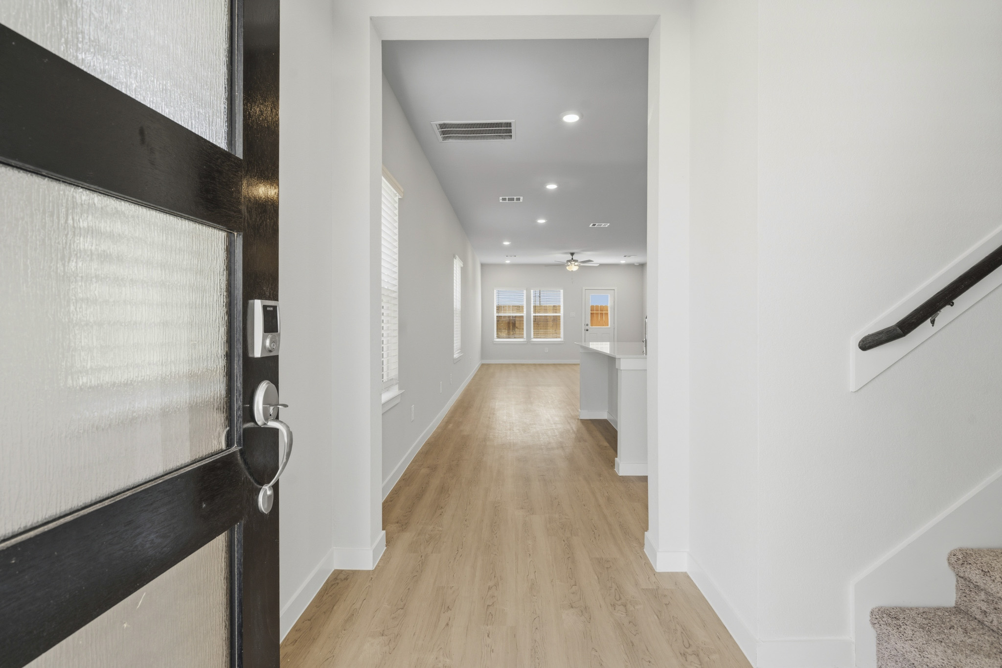 A hallway with white walls.