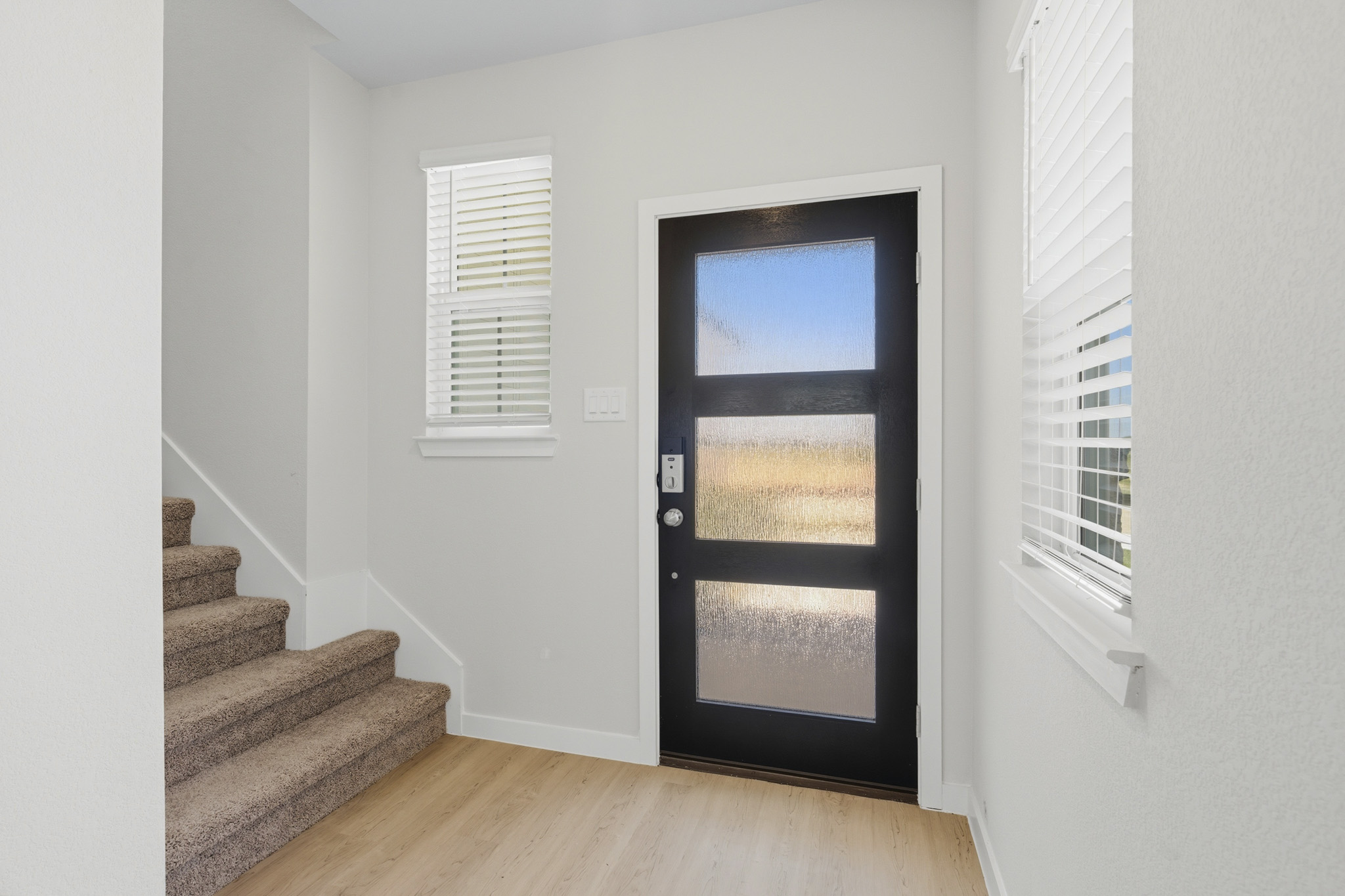 A room with a door and windows.