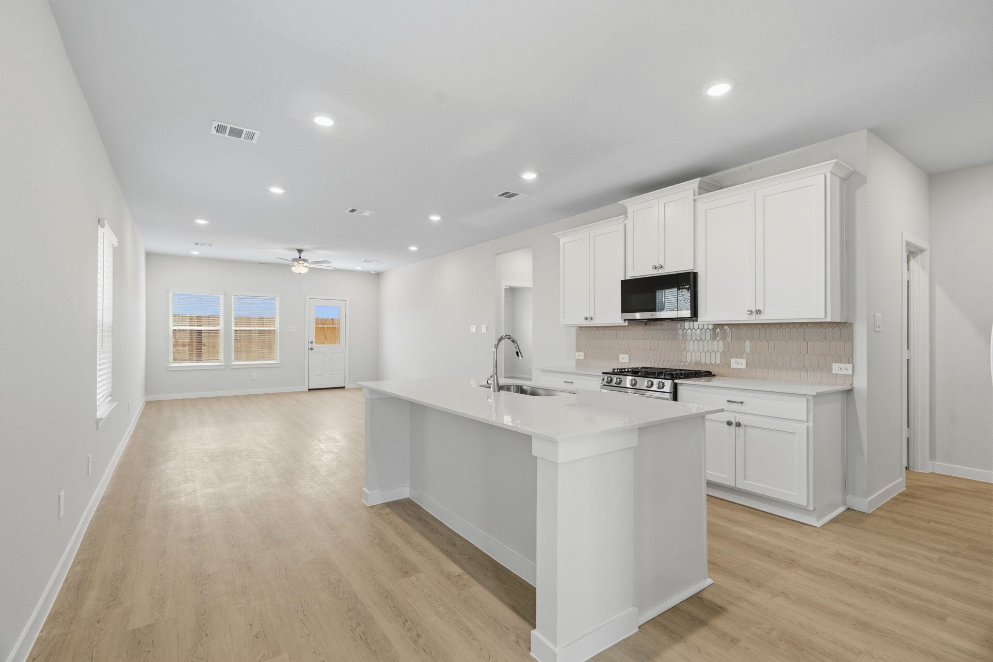 A kitchen with white cabinets.