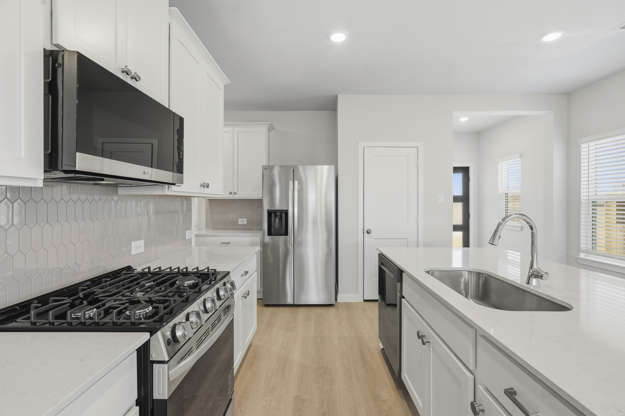 A kitchen with white cabinets.