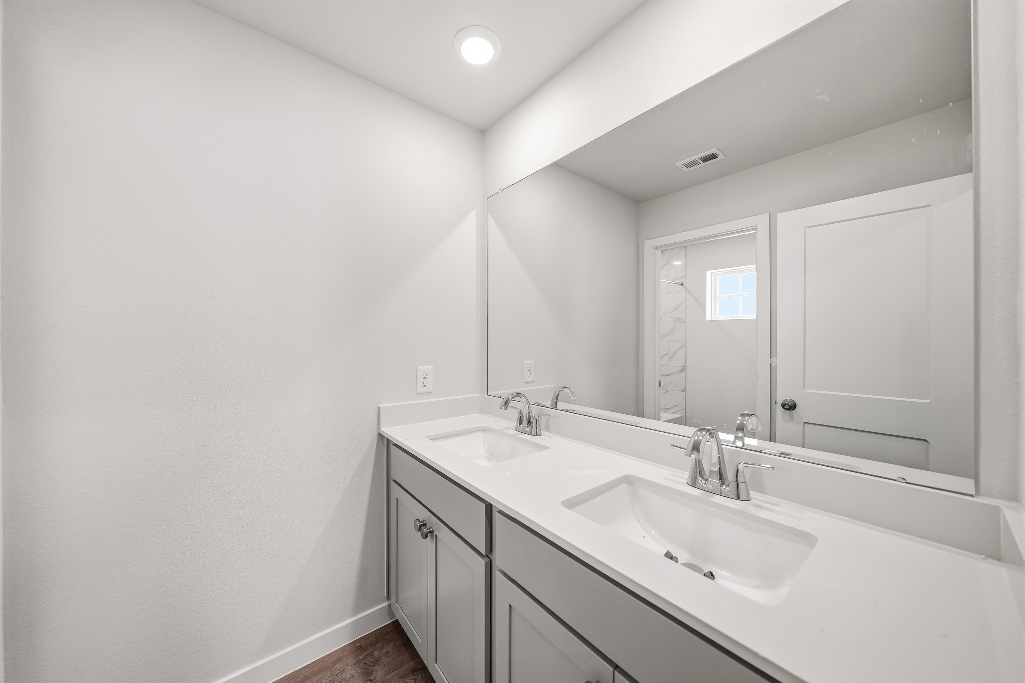 A bathroom with sinks and mirrors.