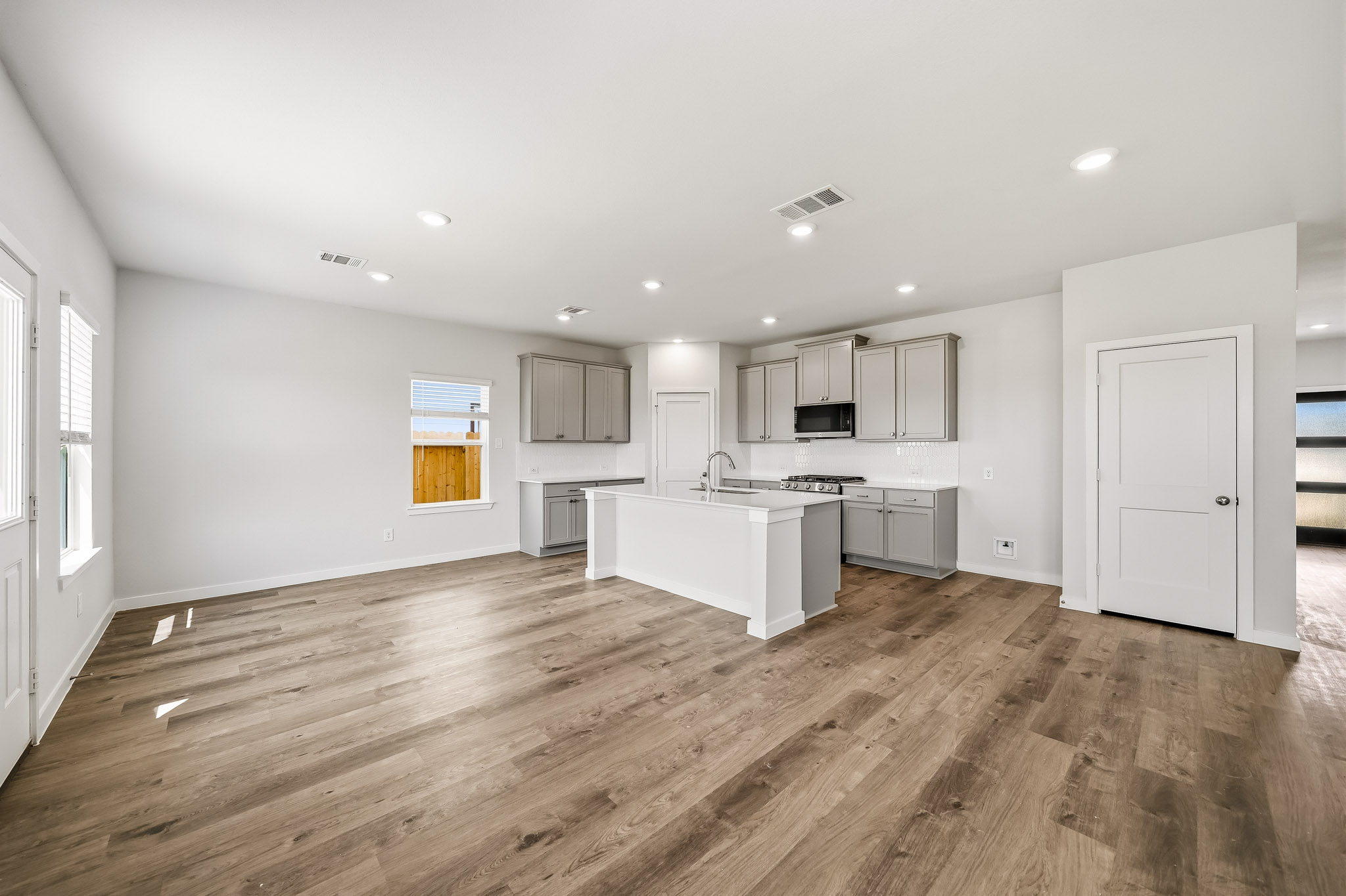 A large kitchen with white cabinets.