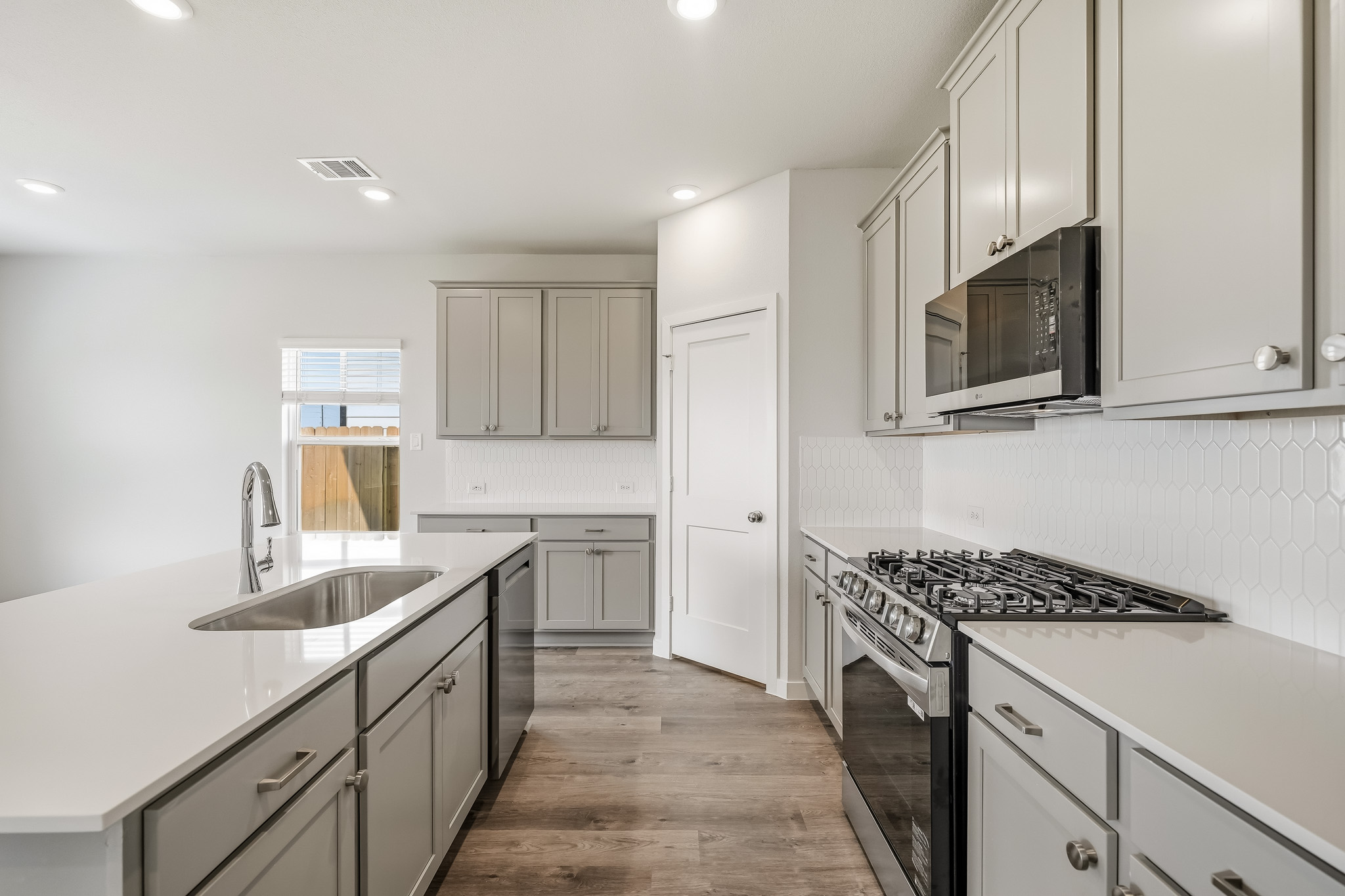 A kitchen with white cabinets.