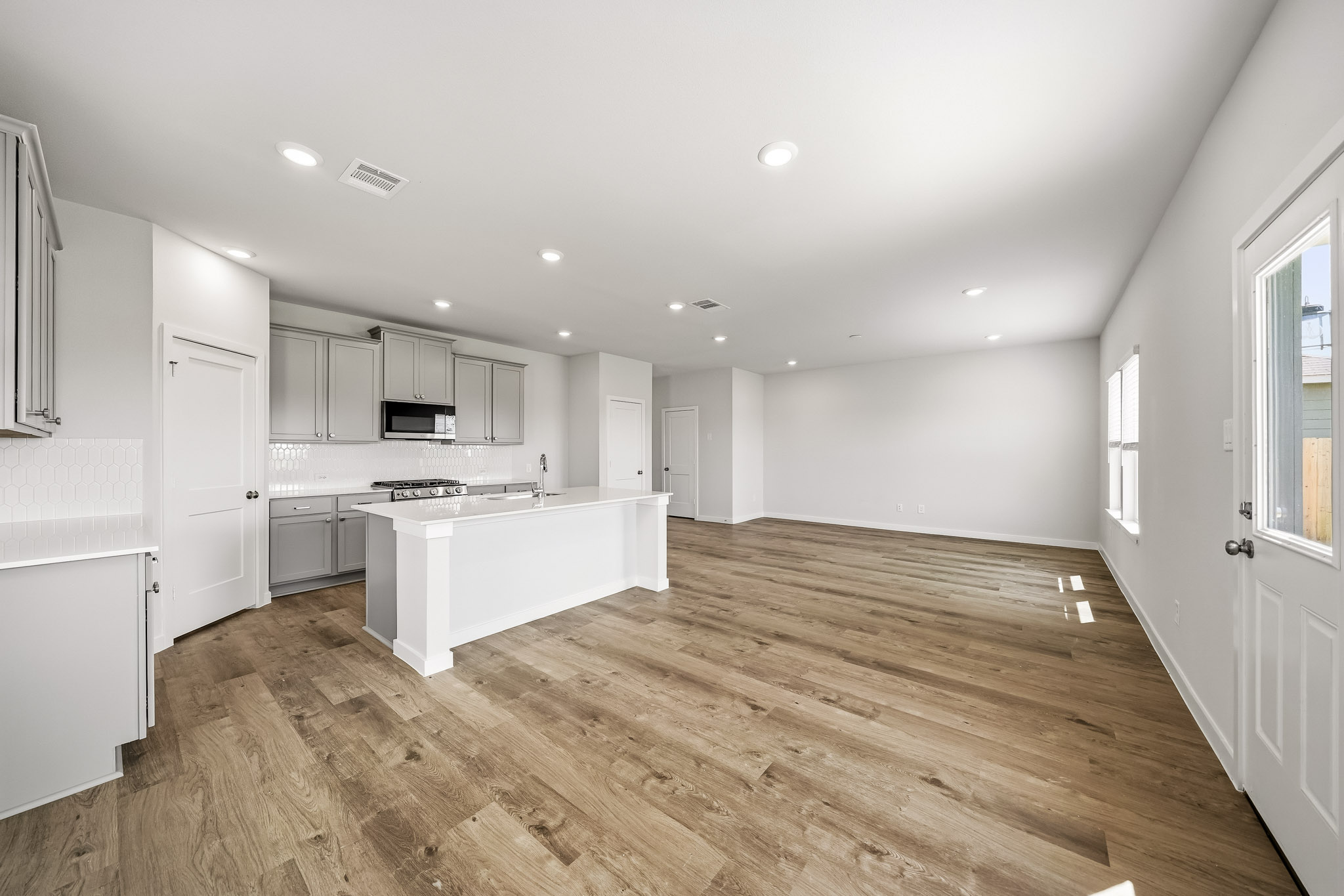 A large kitchen with white cabinets.