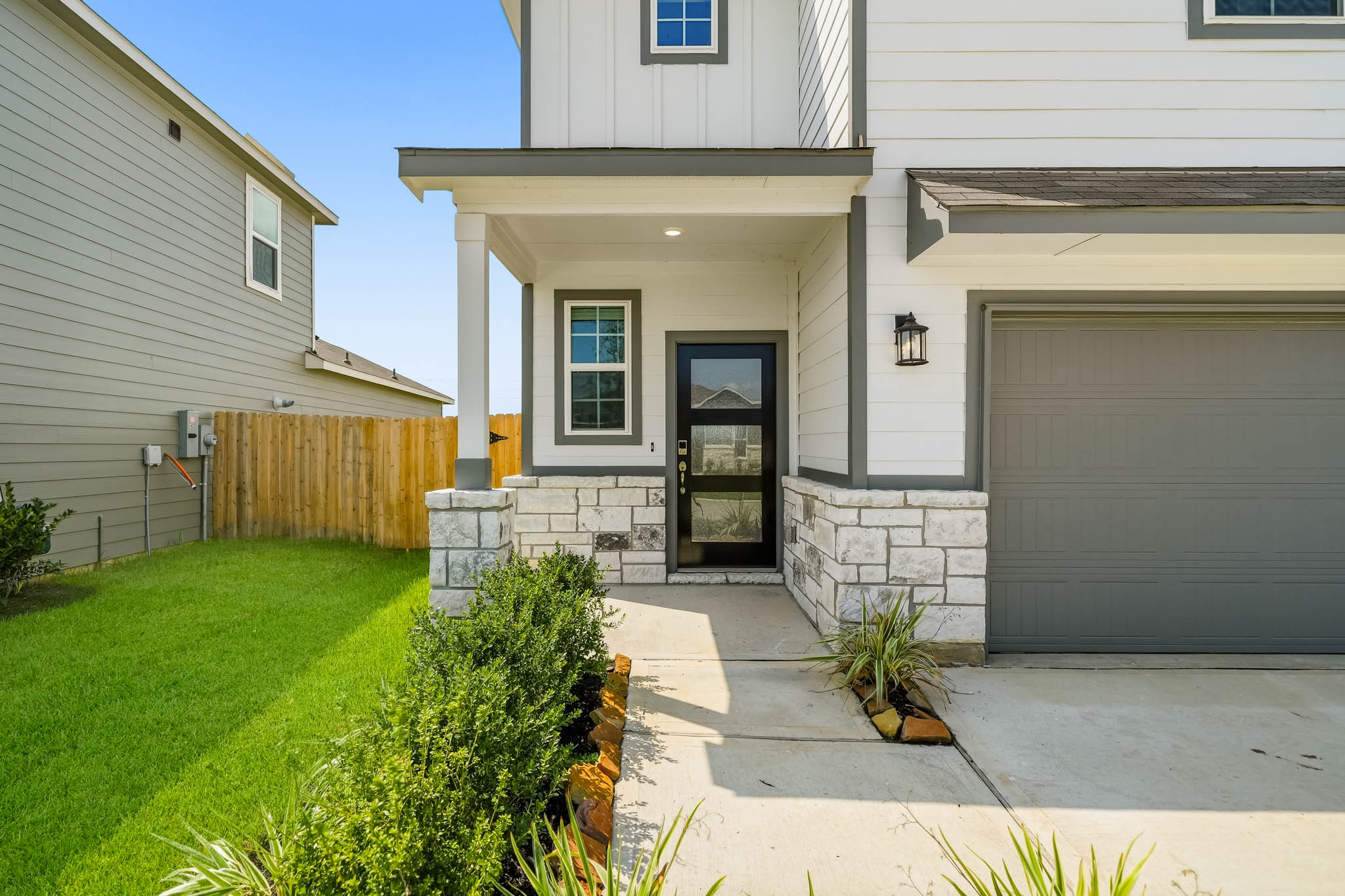 A house with a garage and a lawn.