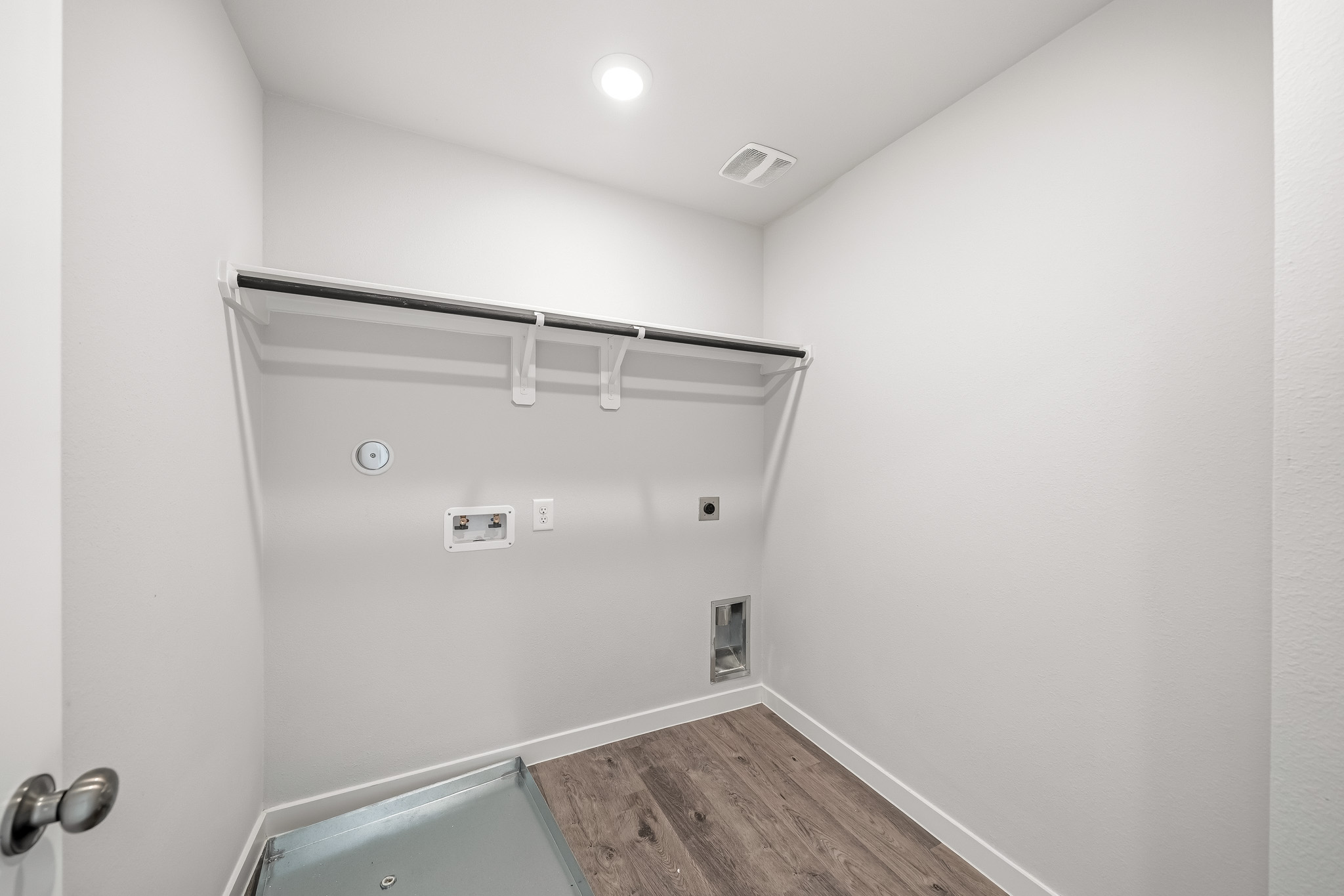 A shower with a wood floor.