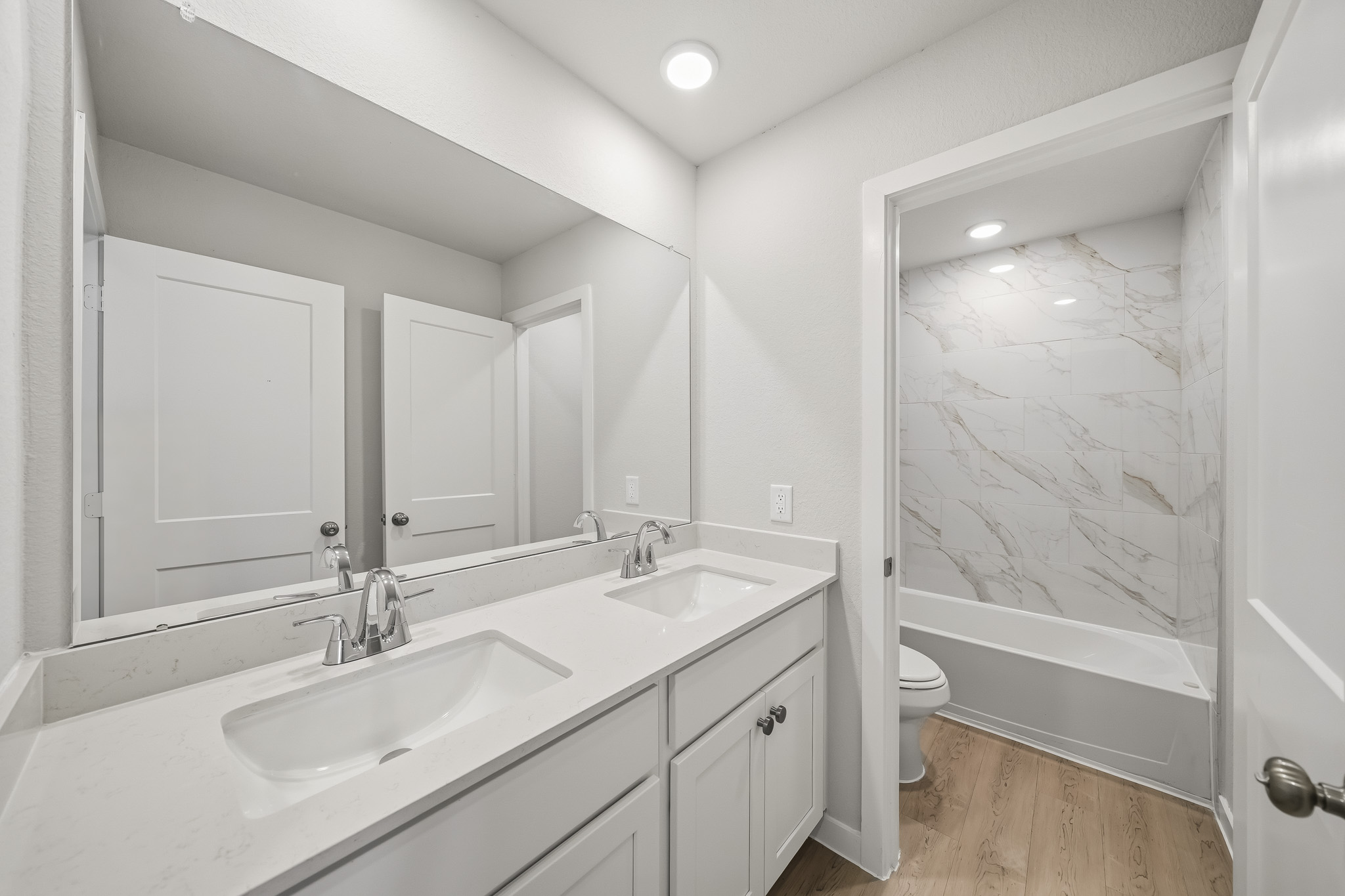 A bathroom with a tub sink and toilet.