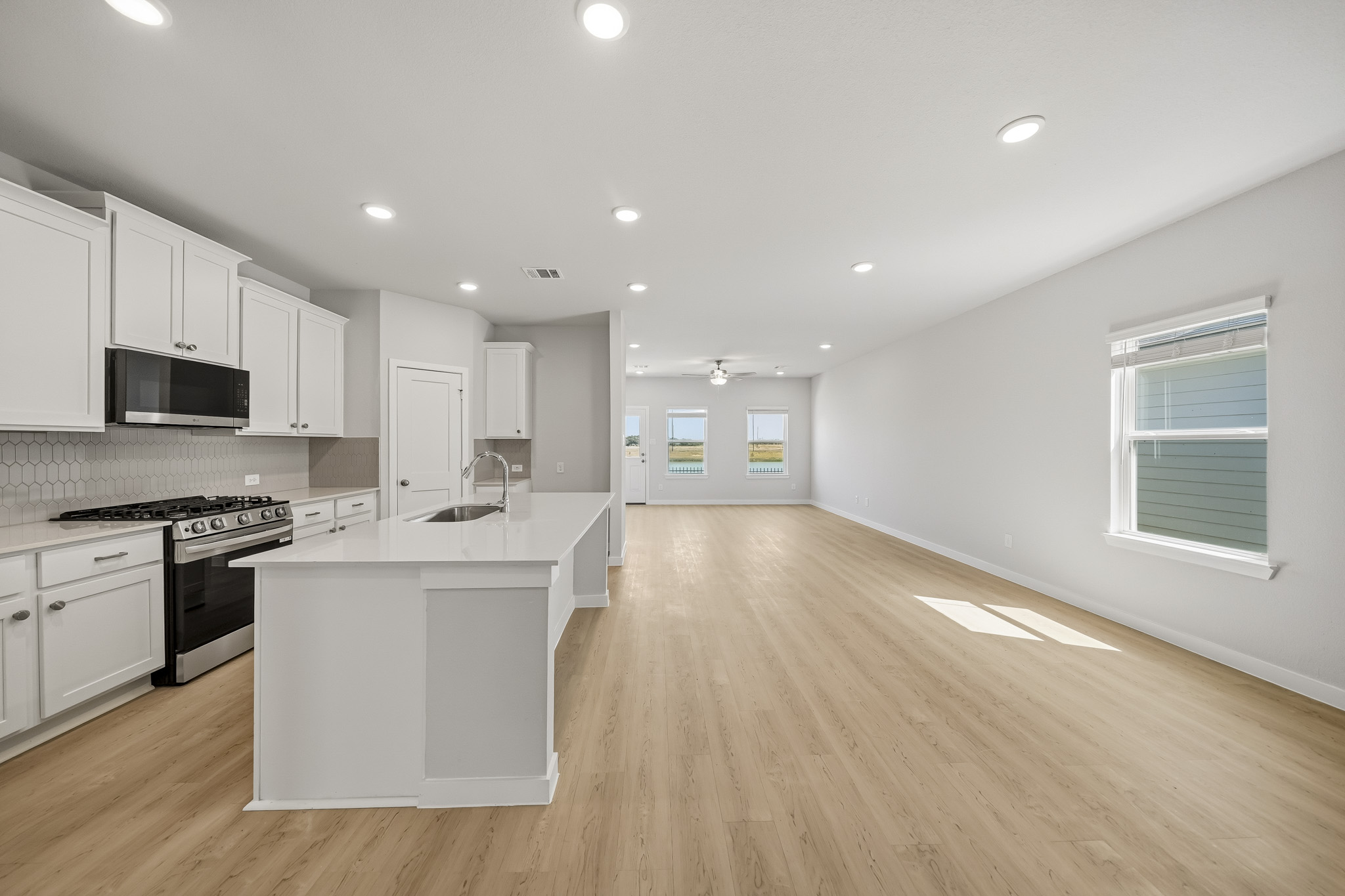 A kitchen with white cabinets.