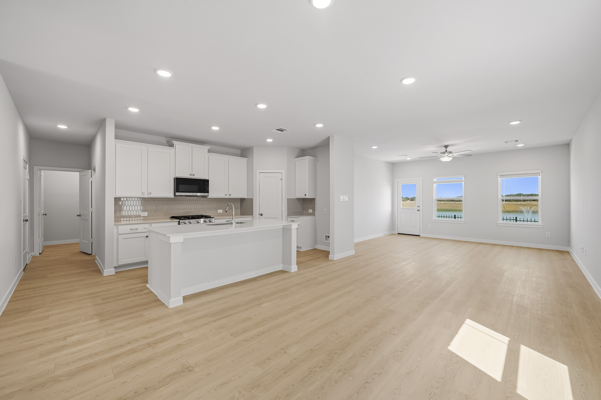 A large kitchen with white cabinets.