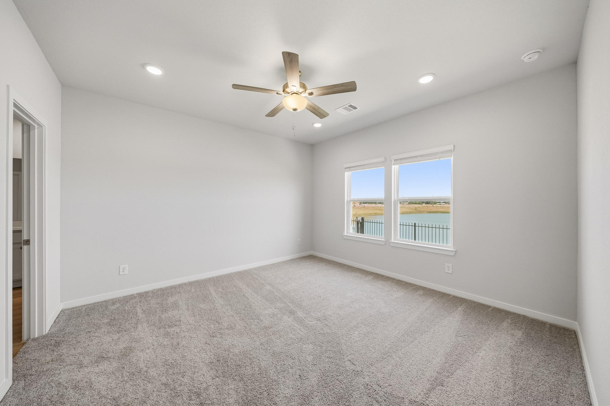 A room with a ceiling fan and a window.