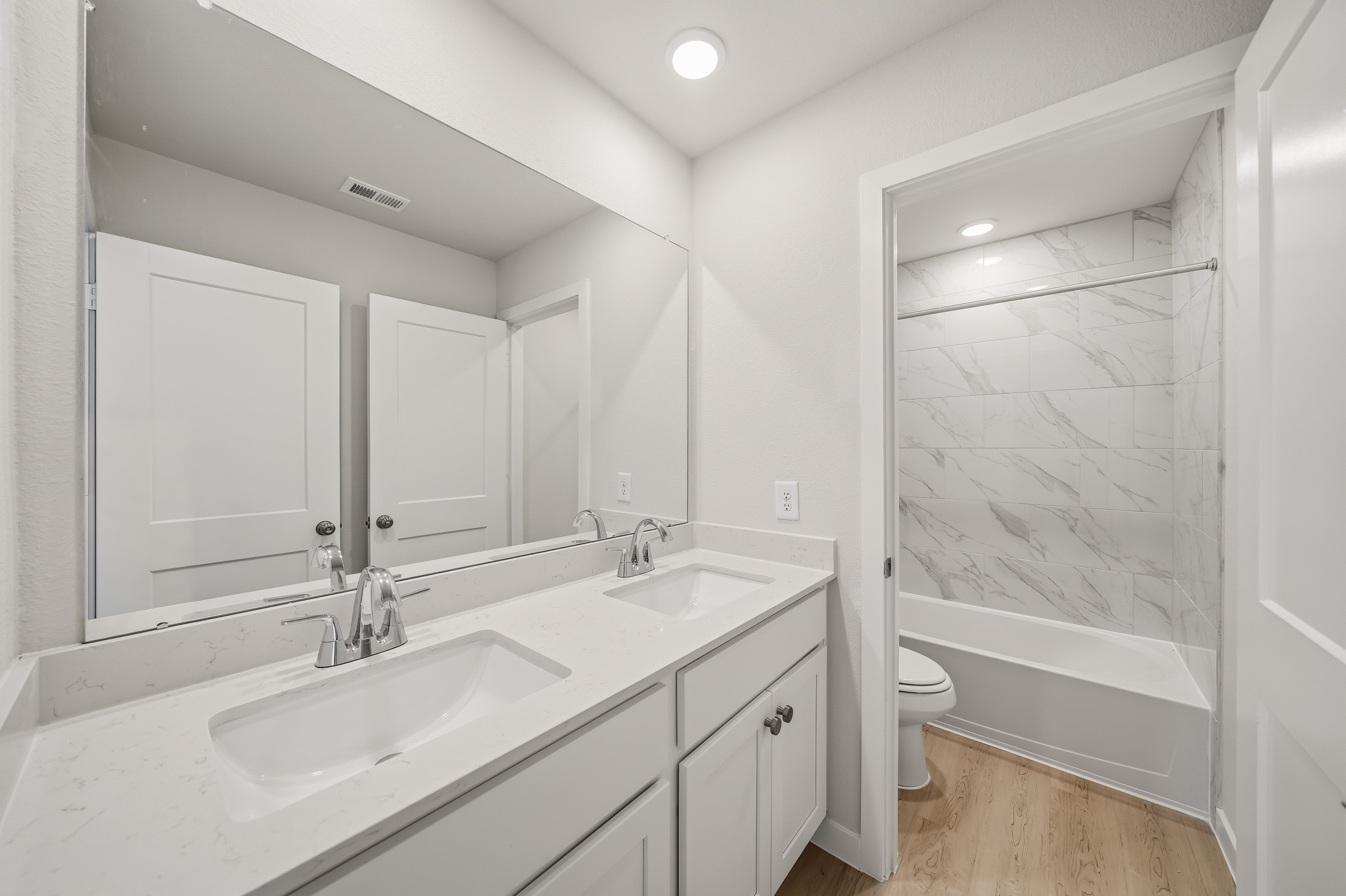 A bathroom with a tub sink and toilet.