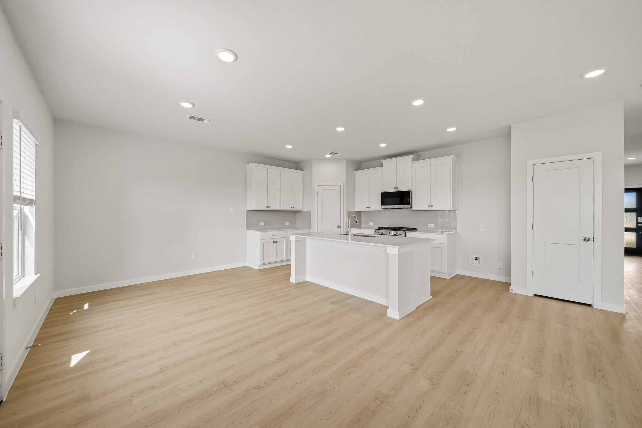 A large kitchen with white cabinets.