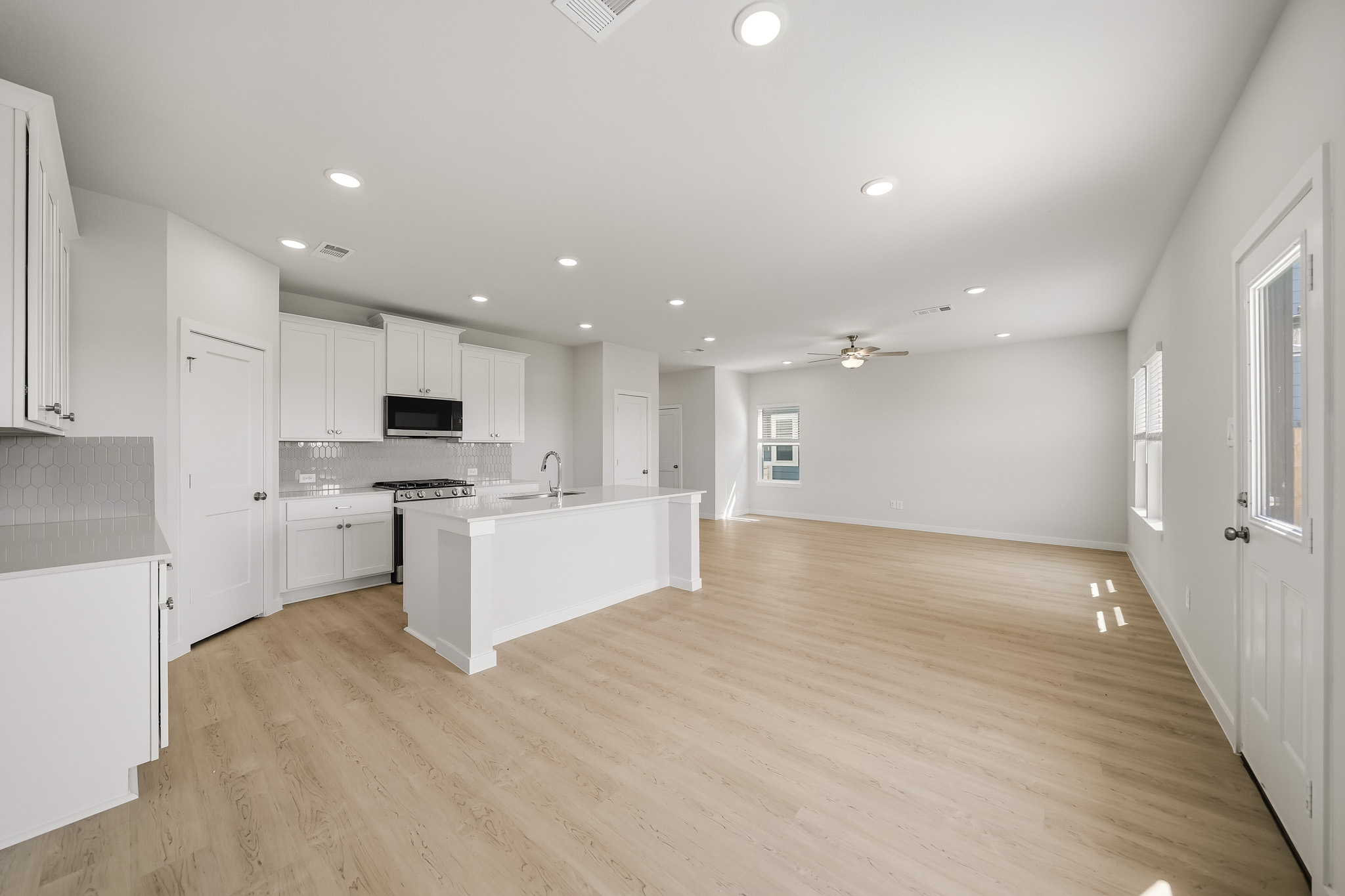 A large kitchen with white cabinets.