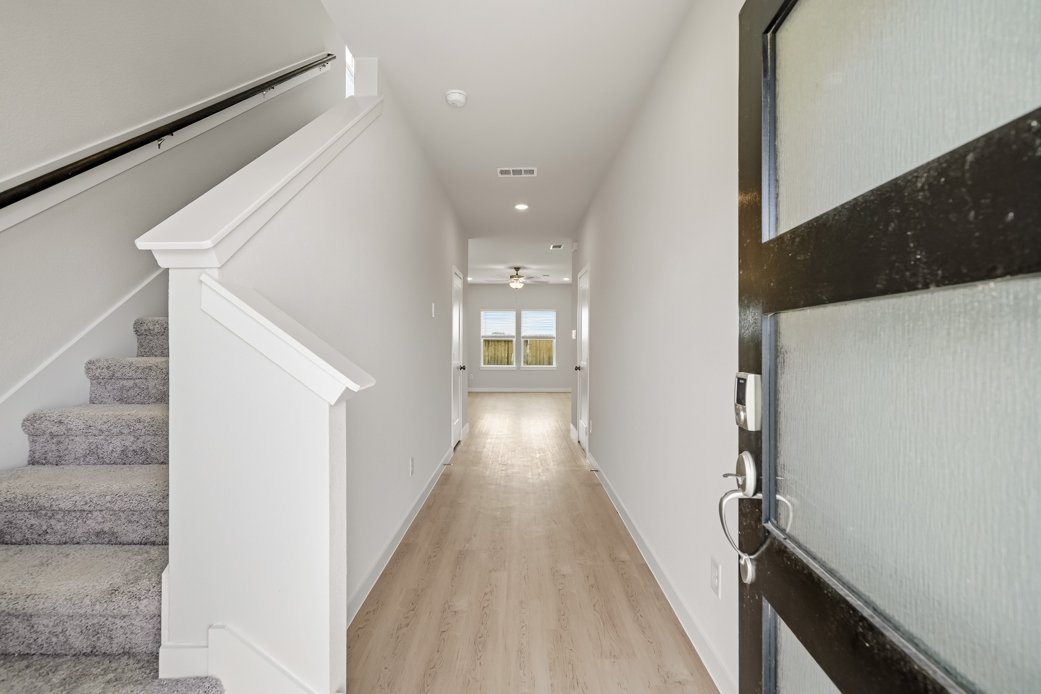 A hallway with white walls.