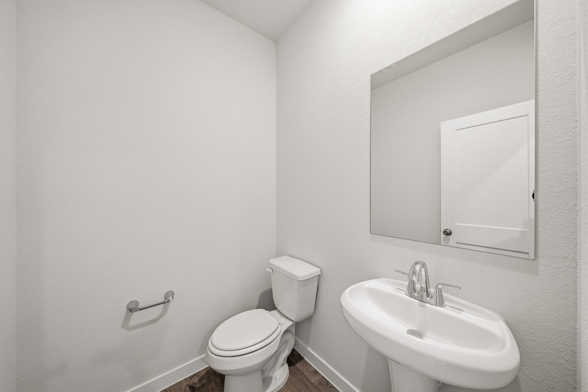 A bathroom with a toilet and sink.
