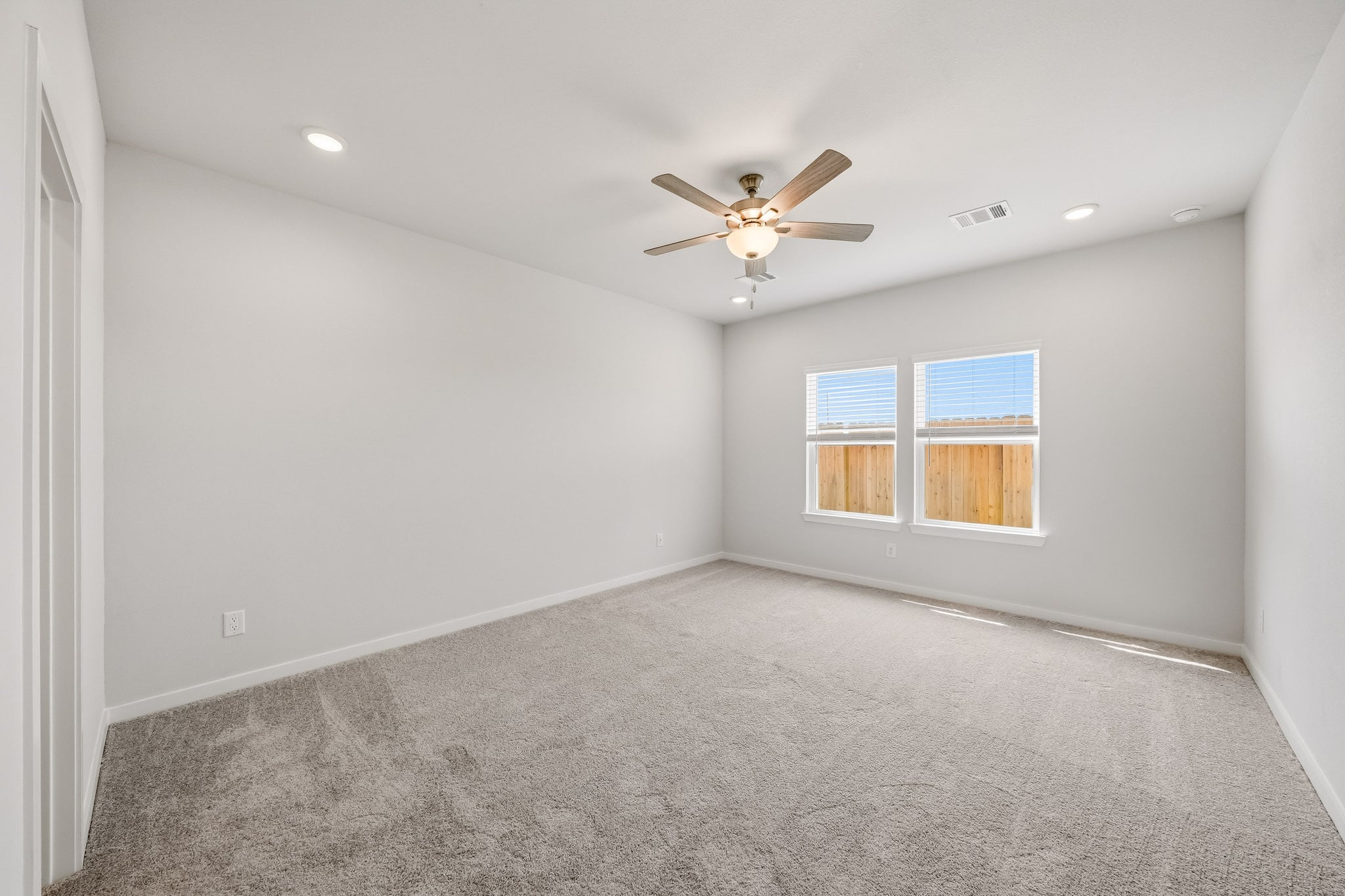 A room with a ceiling fan and a ceiling fan.