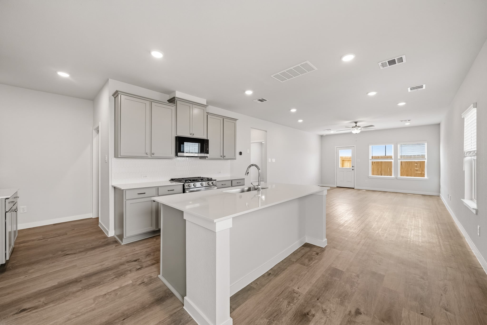 A kitchen with white cabinets.