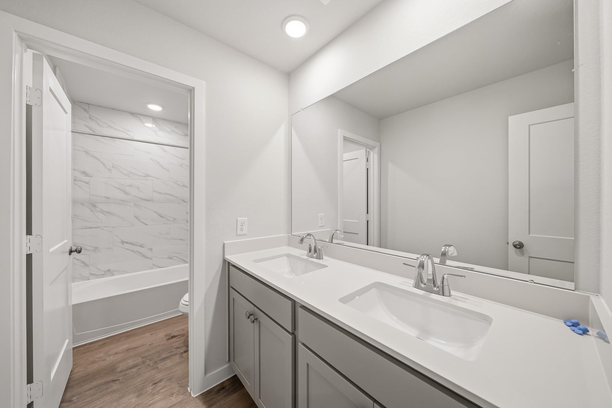 A bathroom with a tub sink and a shower.