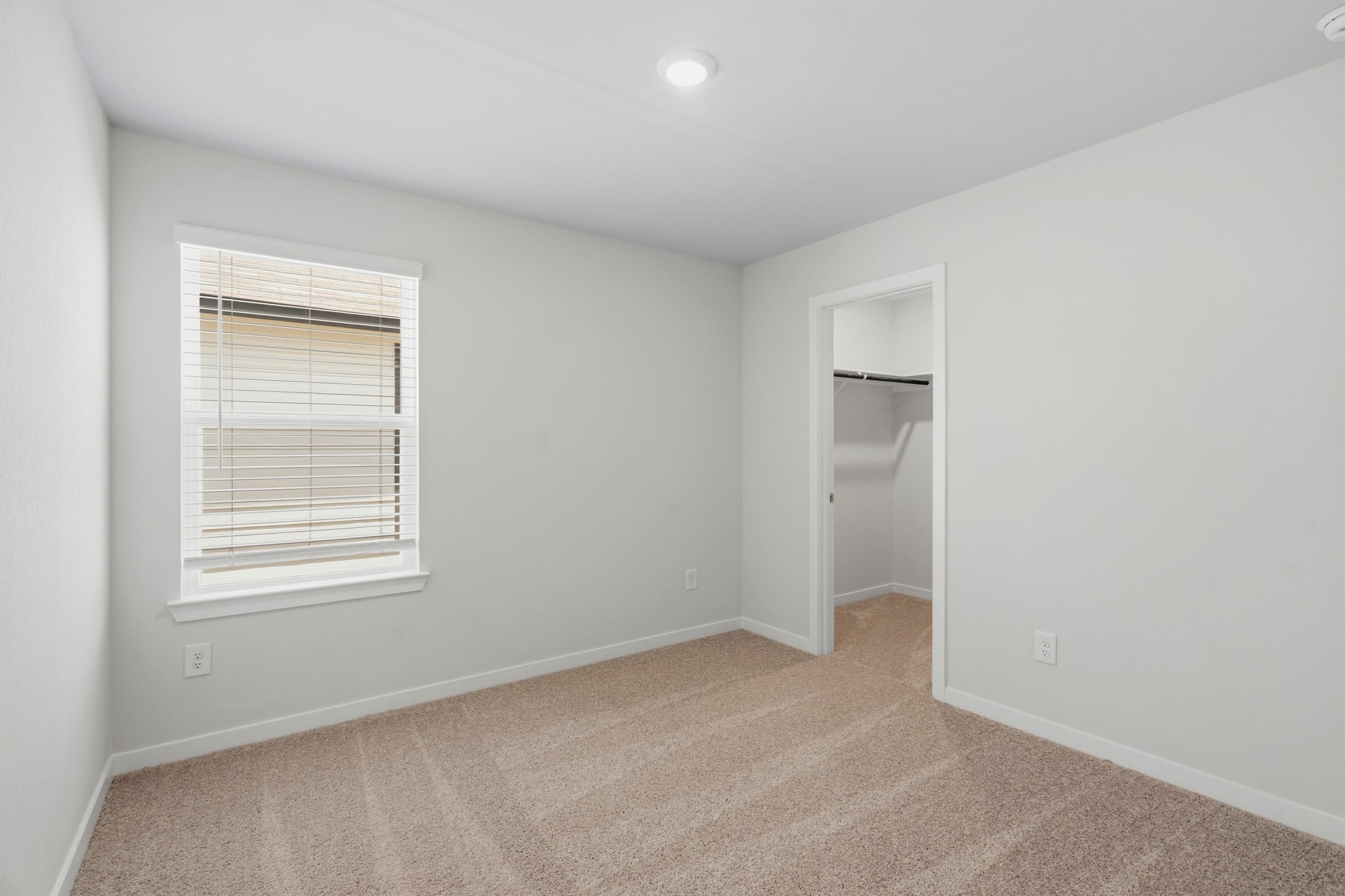 A room with a shelf and a window.