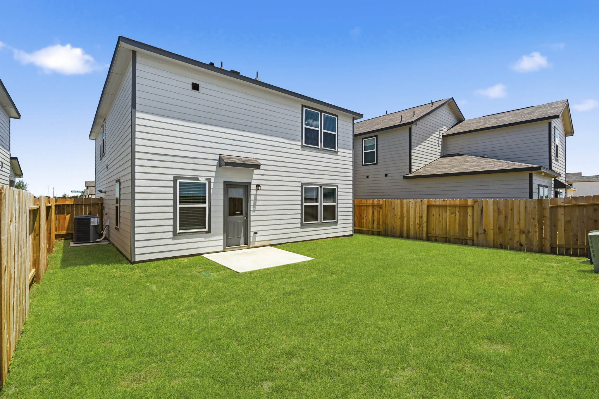 A house with a fence and grass.