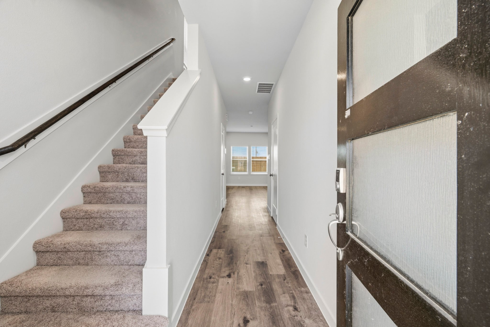 A long hallway with white walls.