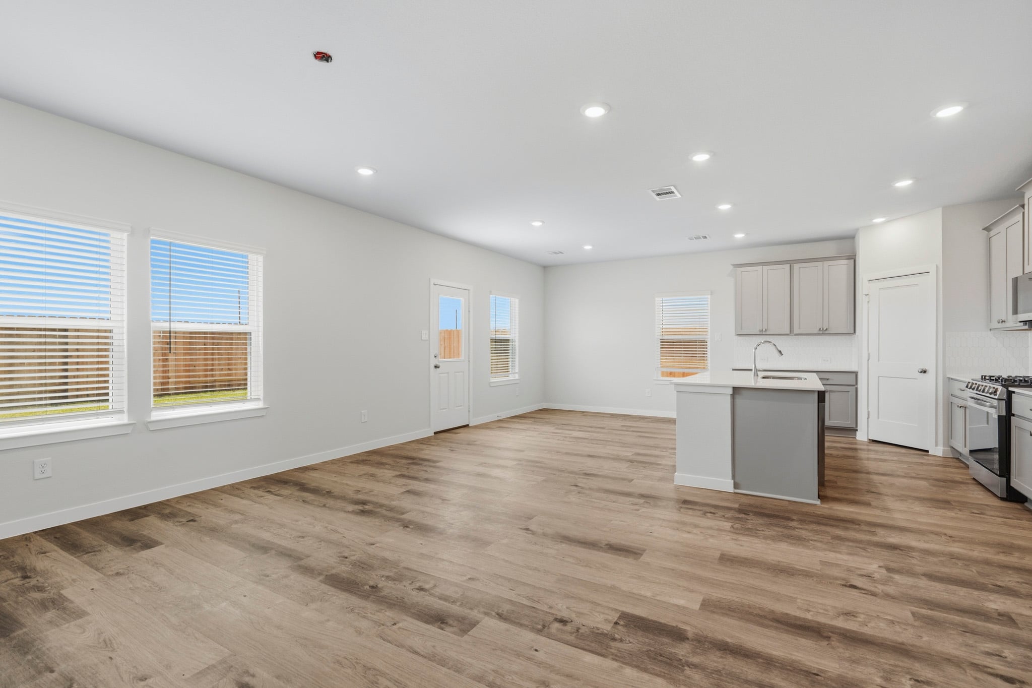 A kitchen with white cabinets.