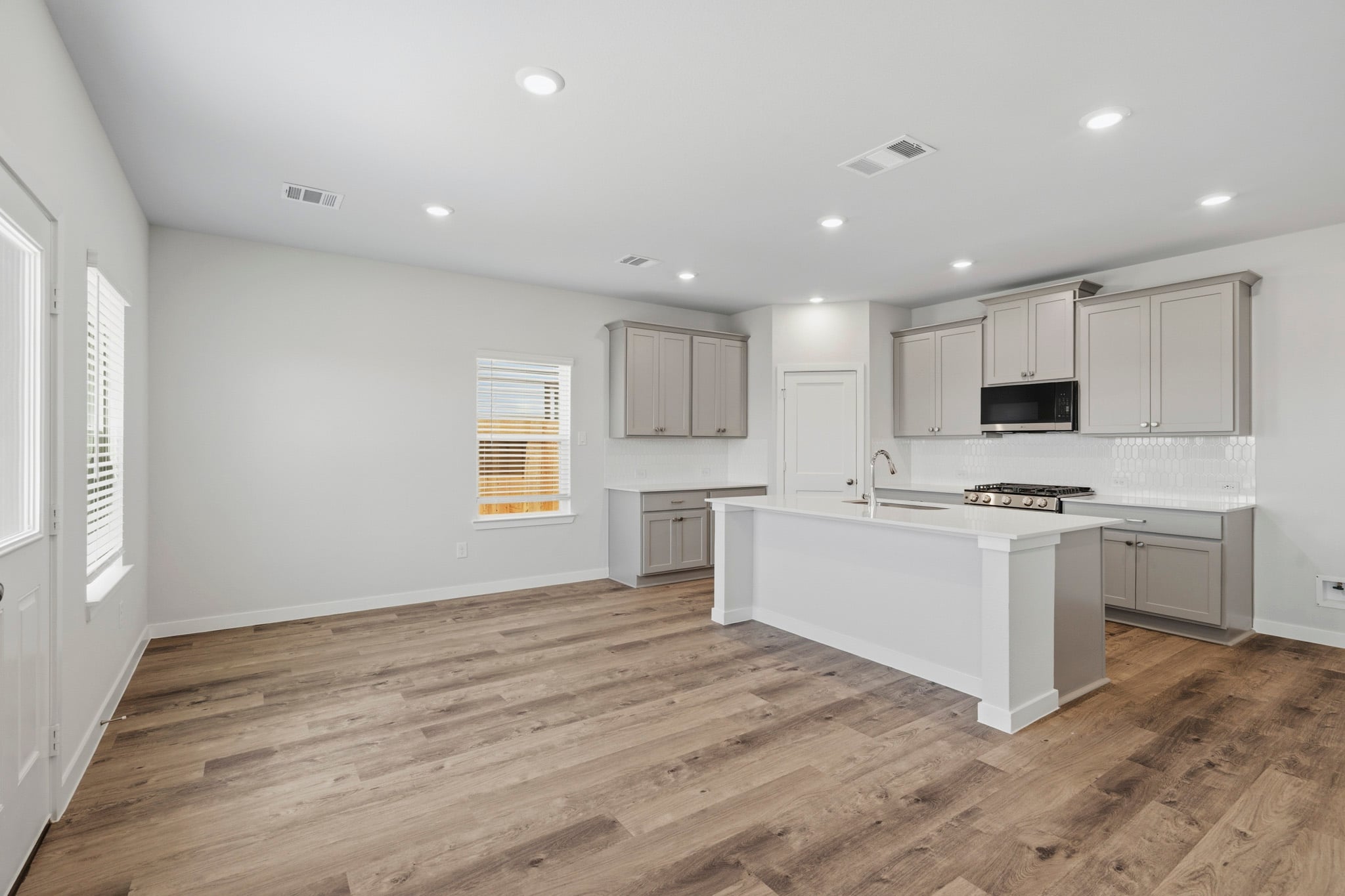 A kitchen with white cabinets.