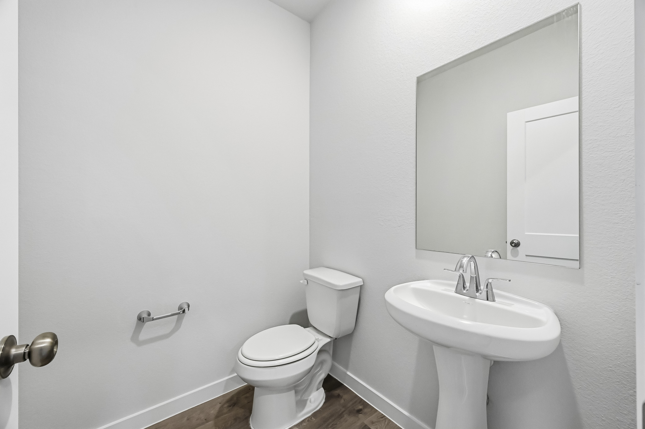 A bathroom with a toilet and sink.