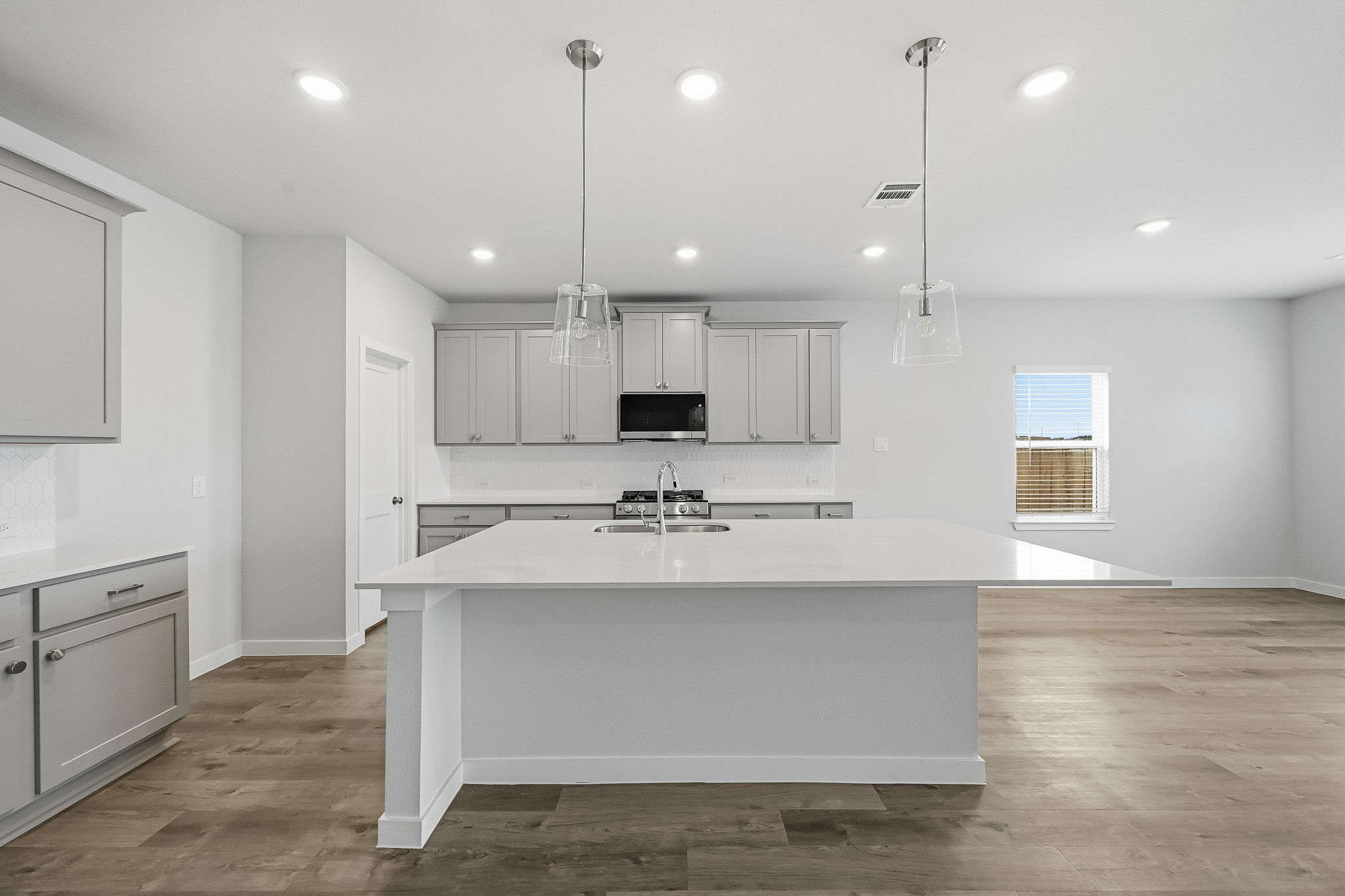 A kitchen with white cabinets.