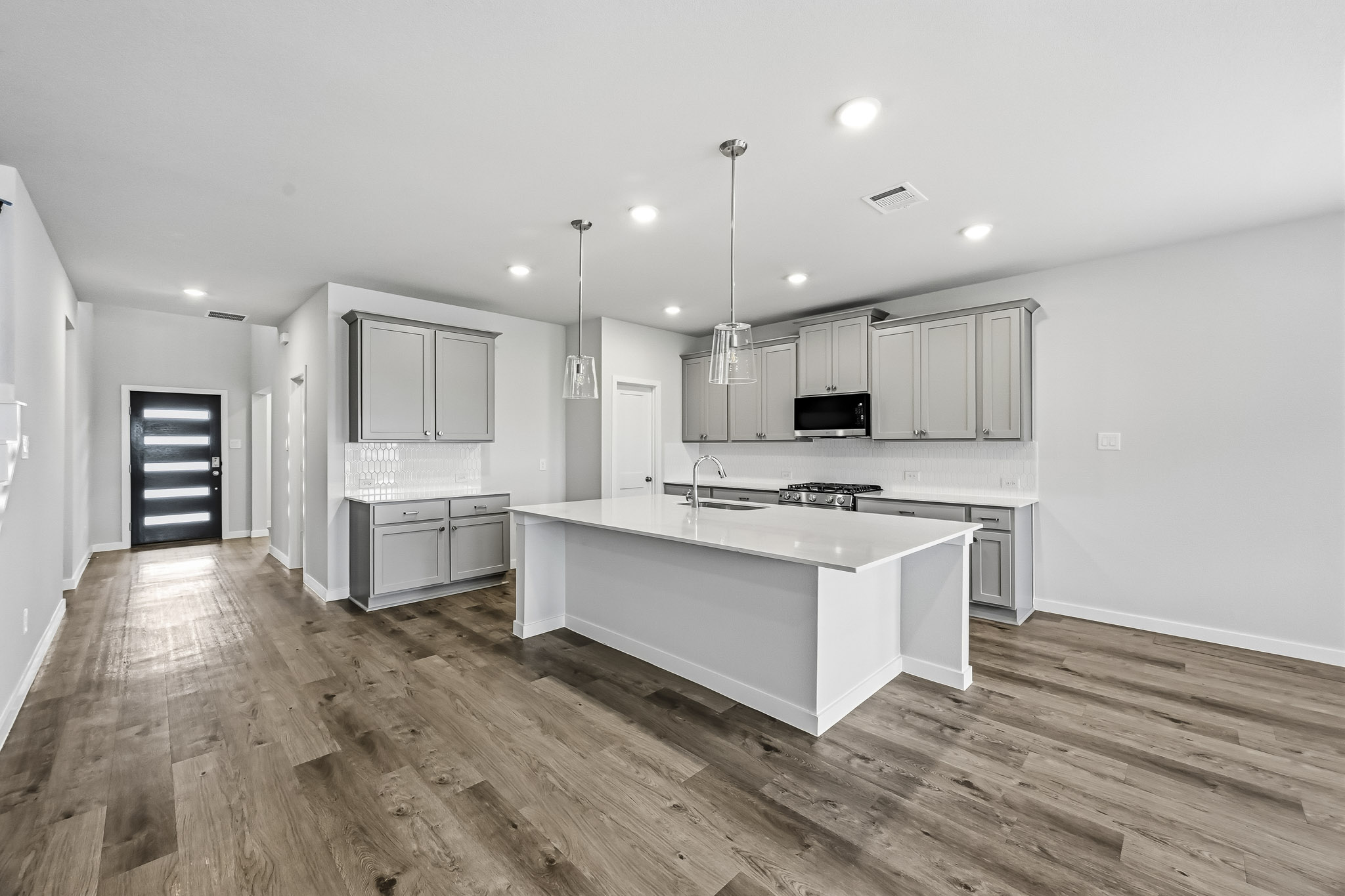 A kitchen with white cabinets.