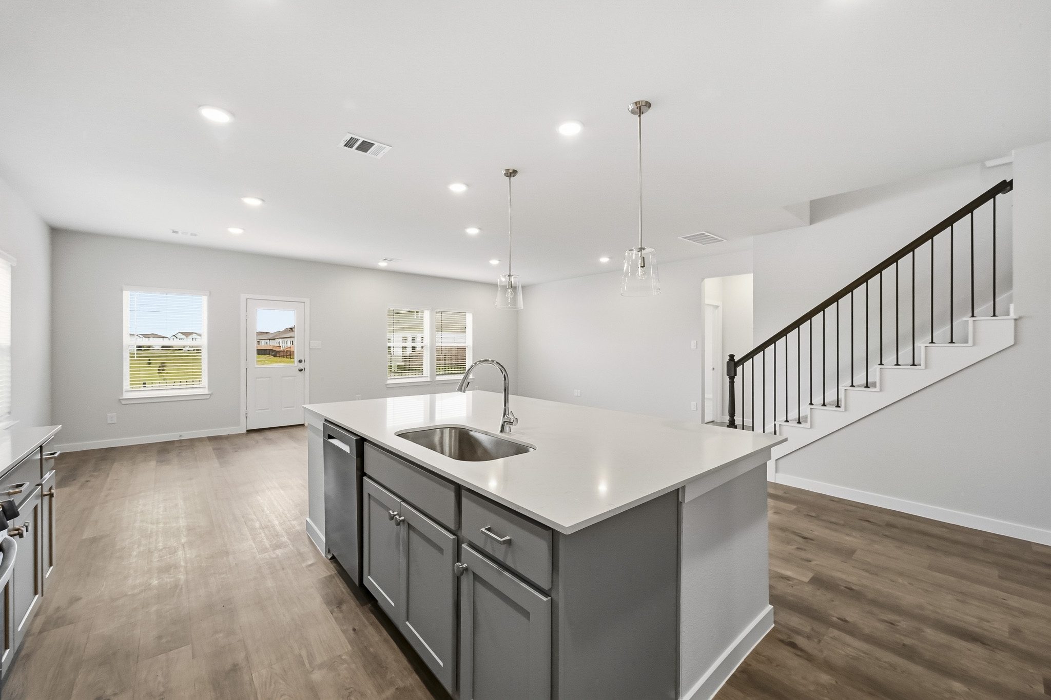 A kitchen with a wood floor.