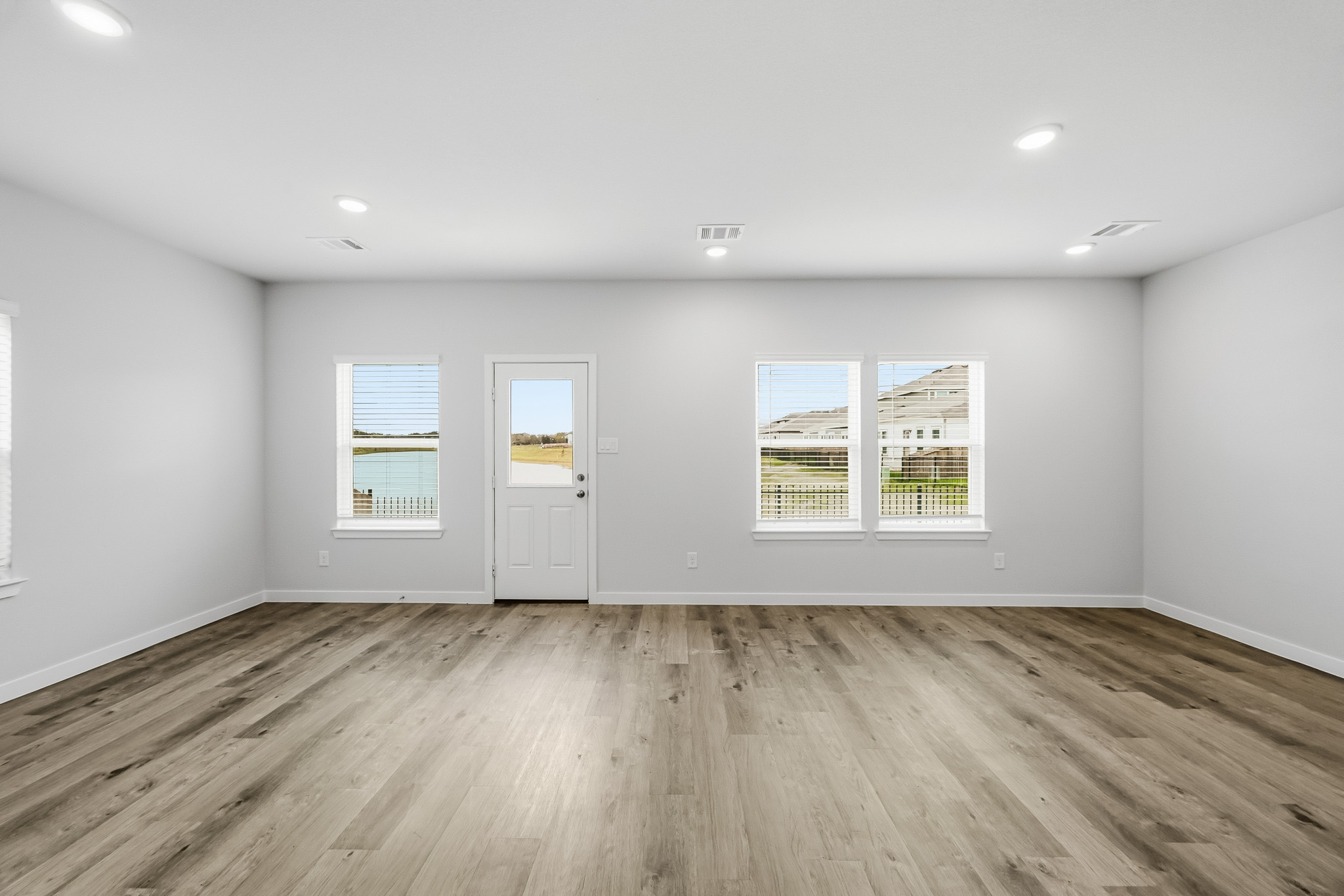 A room with white walls and a wood floor.