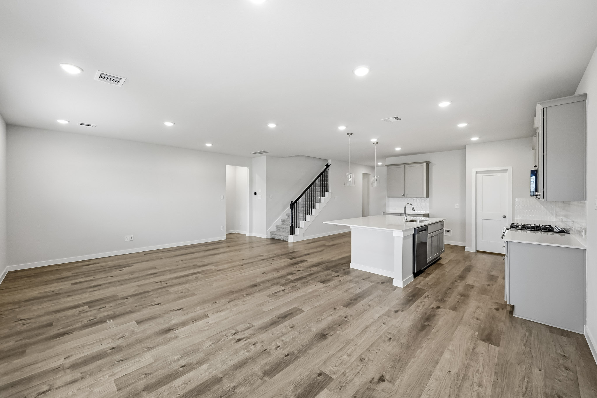 A large kitchen with wood floors.