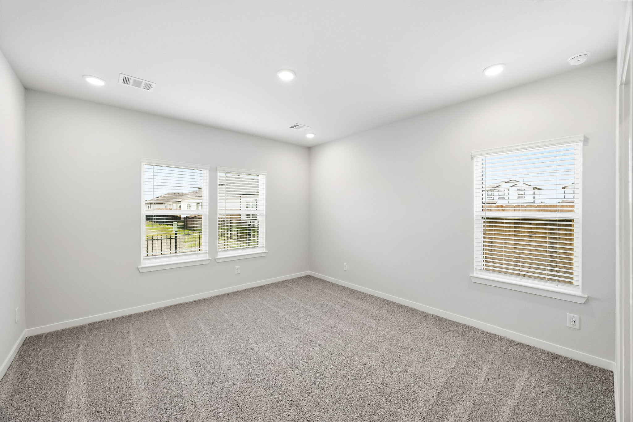 A room with a window and blinds.