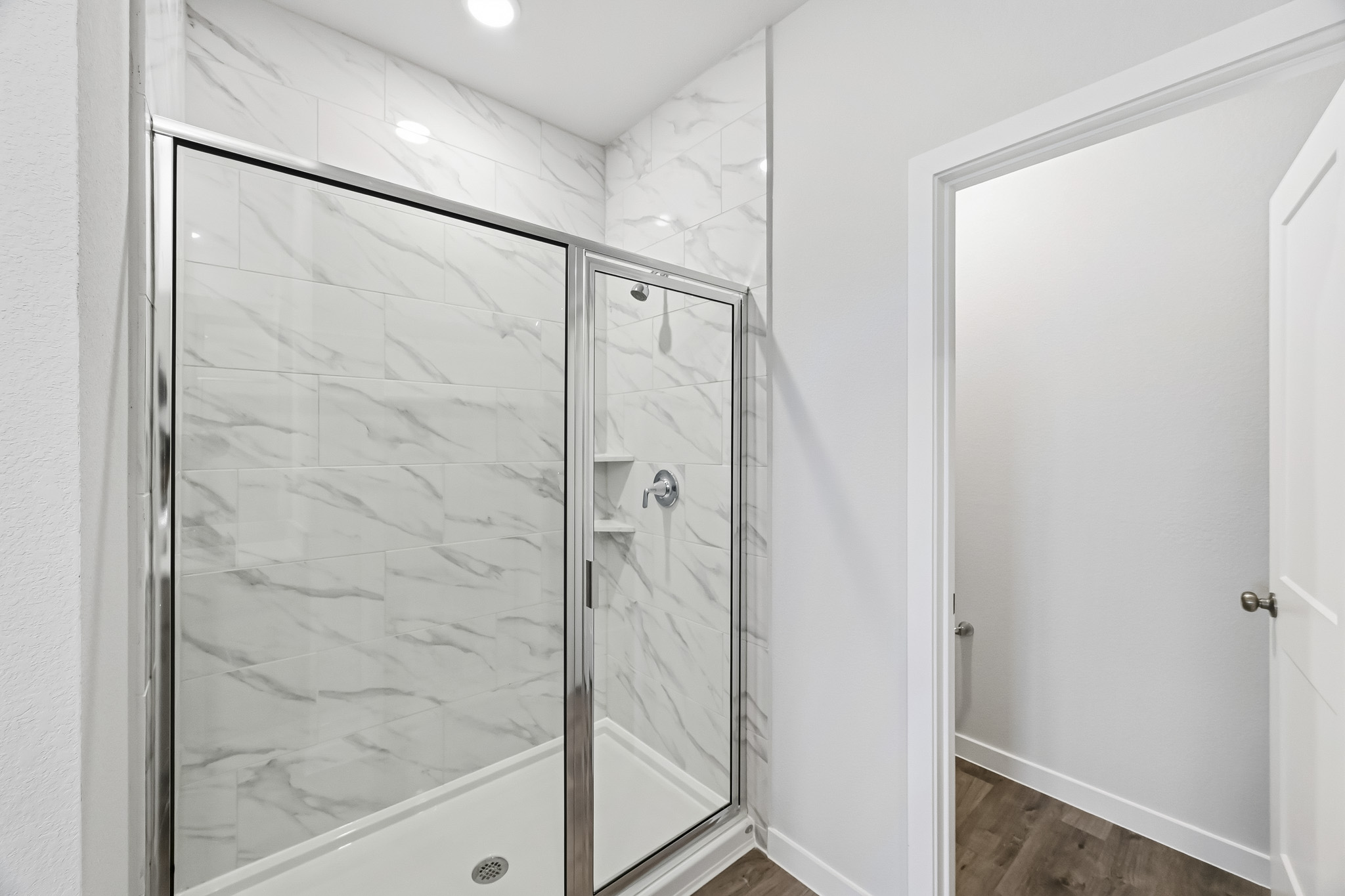 A shower with a glass door.