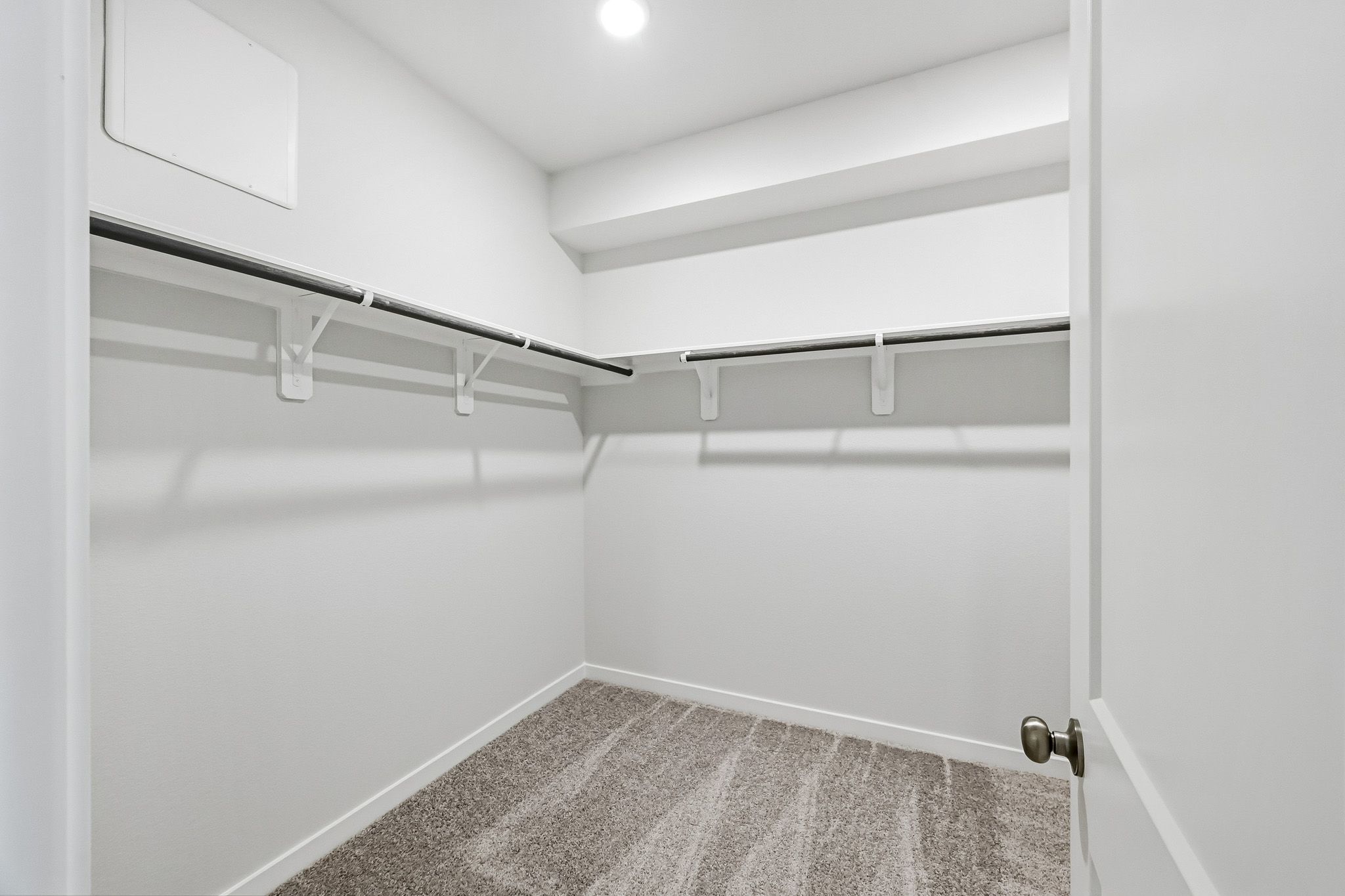 A white wall with a metal bar.